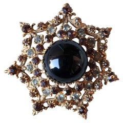 Vintage Florenza Starburst Brooch with Black Cabochon 
Amber Rhinestones