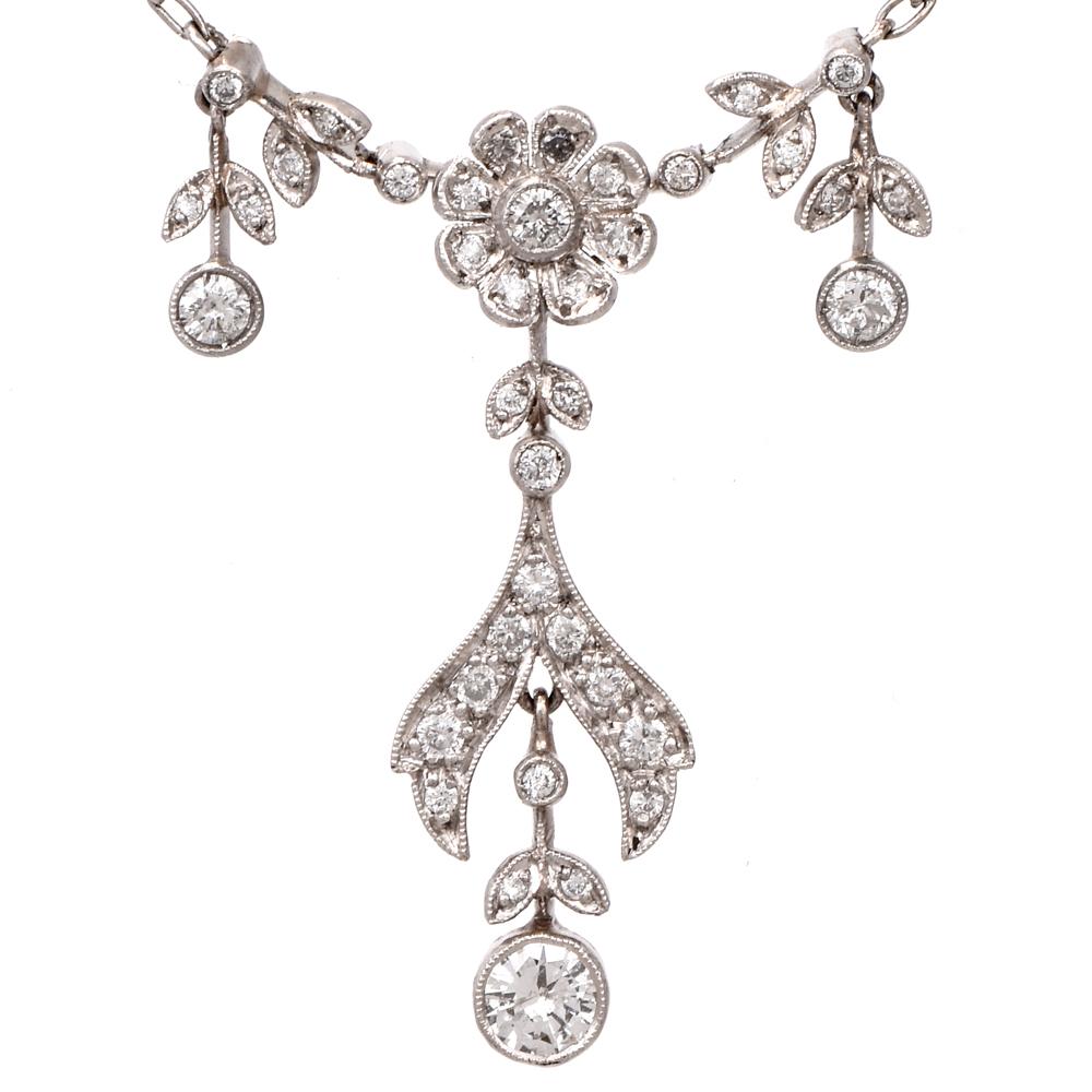 This vintage flower diamond chain necklace is crafted in solid platinum. Displaying a feminine floral dangling design covered in bezel and prong set diamonds approx. 0.85 carats, H-I color, VS-SI clarity. Weighing 6 grams, necklace measures 17” long