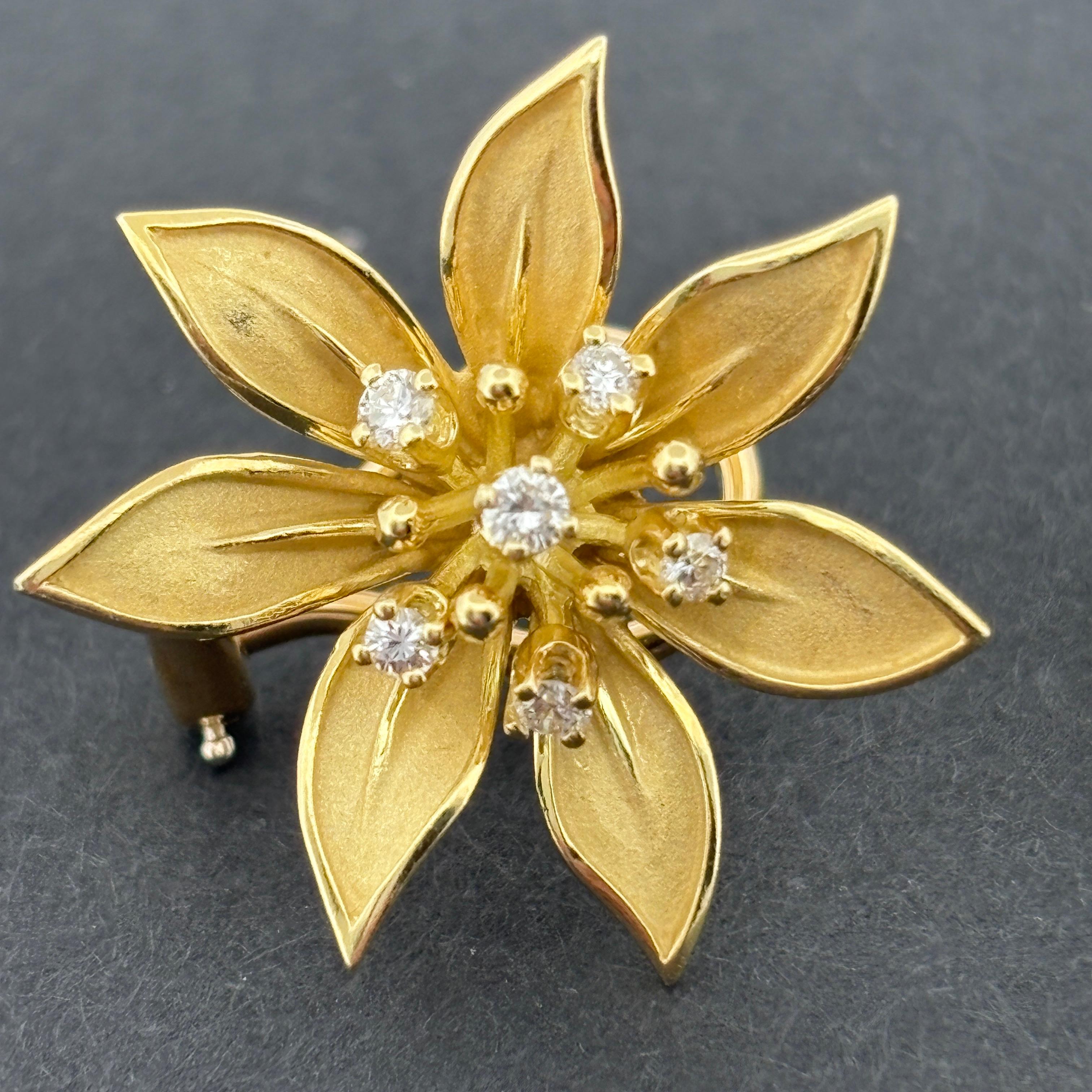 Vintage 18K Yellow Gold Diamond Flower Earrings, ca. 1985

These elegant vintage earrings are crafted in rich 18k yellow gold, designed as stylized six-petal blossoms with a subtle sculptural curve and impeccable detailing. Each flower is accented