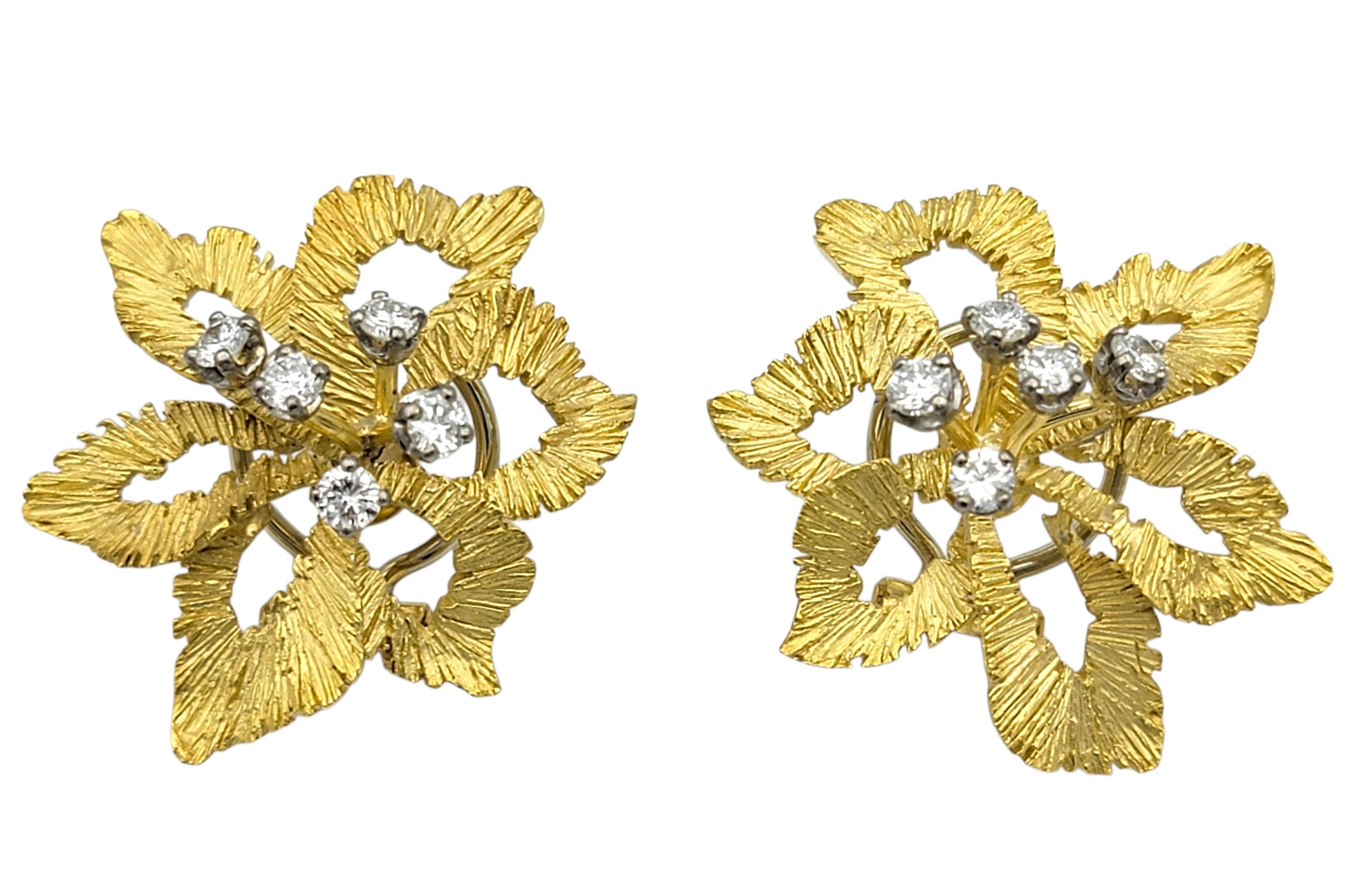 These diamond earrings feature a delicate leaf-inspired design that gives them a soft, elegant presence. Each earring is shaped with gentle curves that mimic natural foliage, creating a graceful and airy silhouette. The diamonds are placed at the