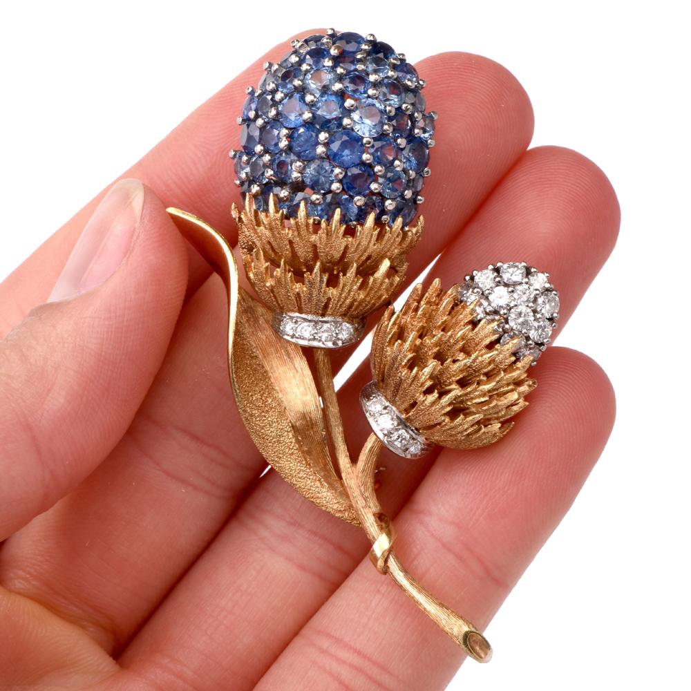 This Retro 1950'S vintage pin brooch of immaculate workmanship and refined aesthetic is hand crafted in matted and textured 18 karat yellow gold, and a touch of white gold applied to the setting of blue sapphires and diamonds. weighing 22.9 grams