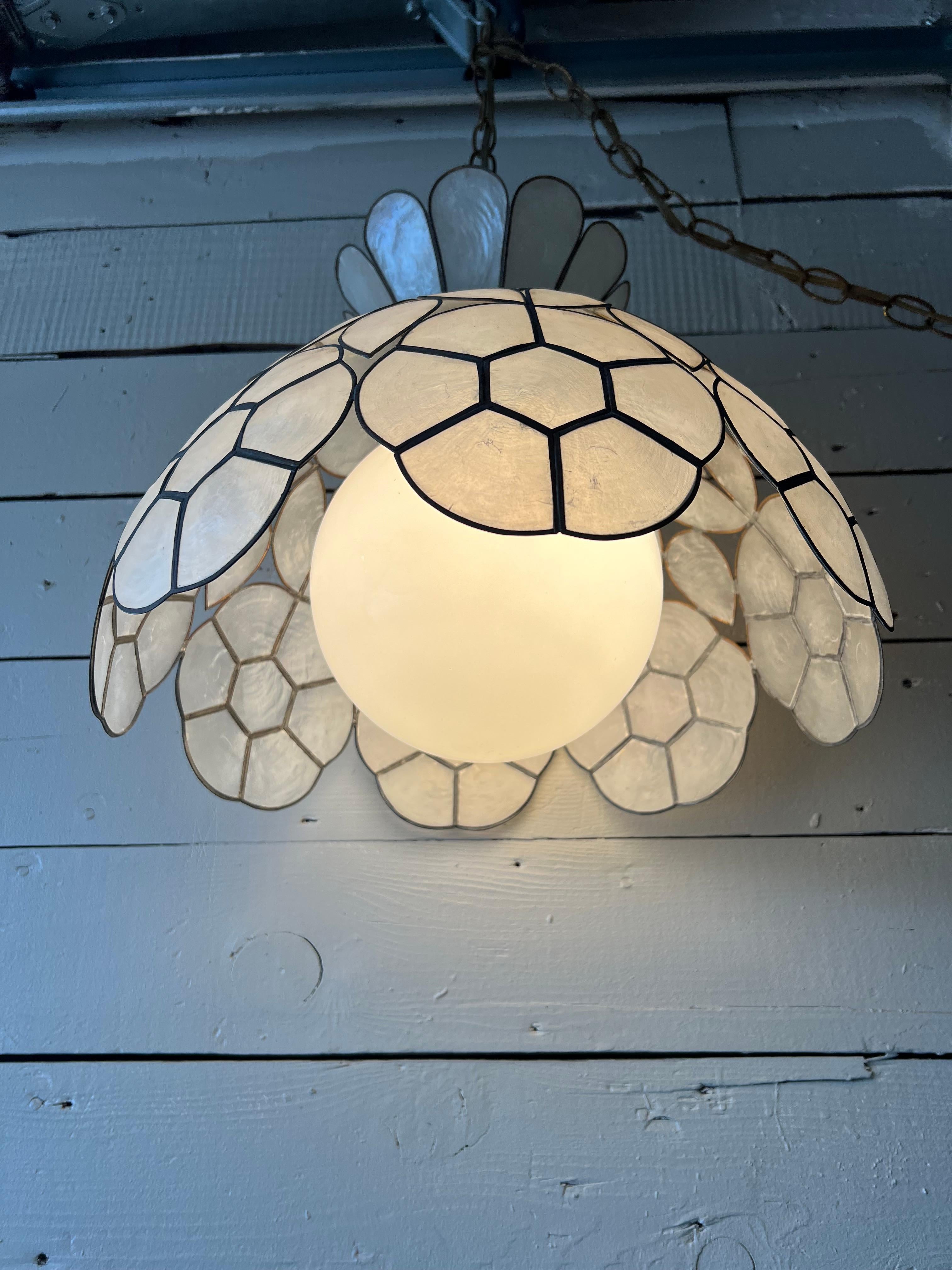 Beautiful, handcrafted capiz shell swag lamp from the 1960s. Unaltered and in original condition. Some tarnishing to top brass and swag chain. On/off switch located on the wire towards the end of the chain. Chain over 8ft long. Perfect for a knook