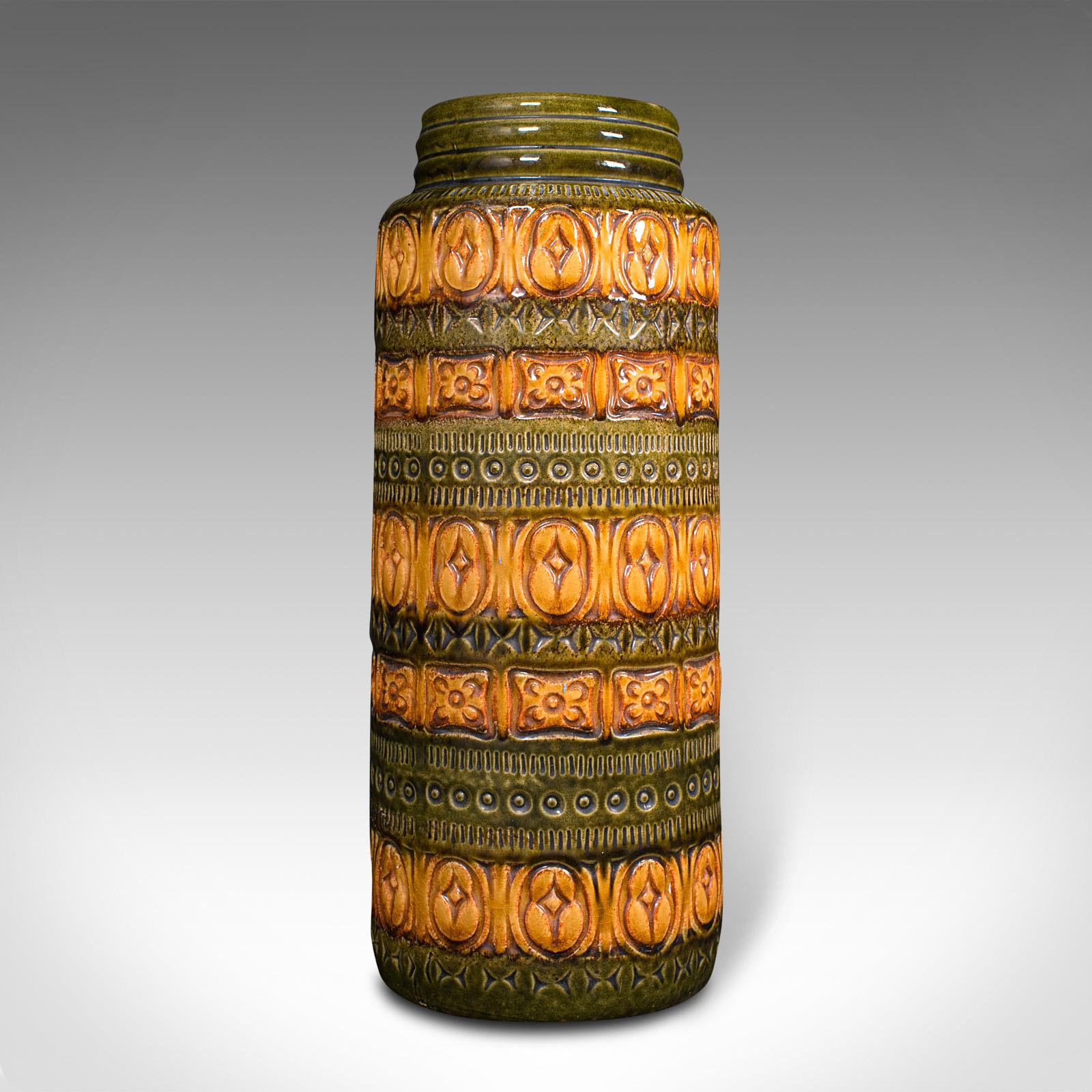 This is a vintage flower vase. A German, ceramic lava slip or decorative hall stick stand, dating to the mid 20th century, circa 1970.

Striking period colour and decoration
Displays a desirable aged patina throughout
Ceramic form decorated with