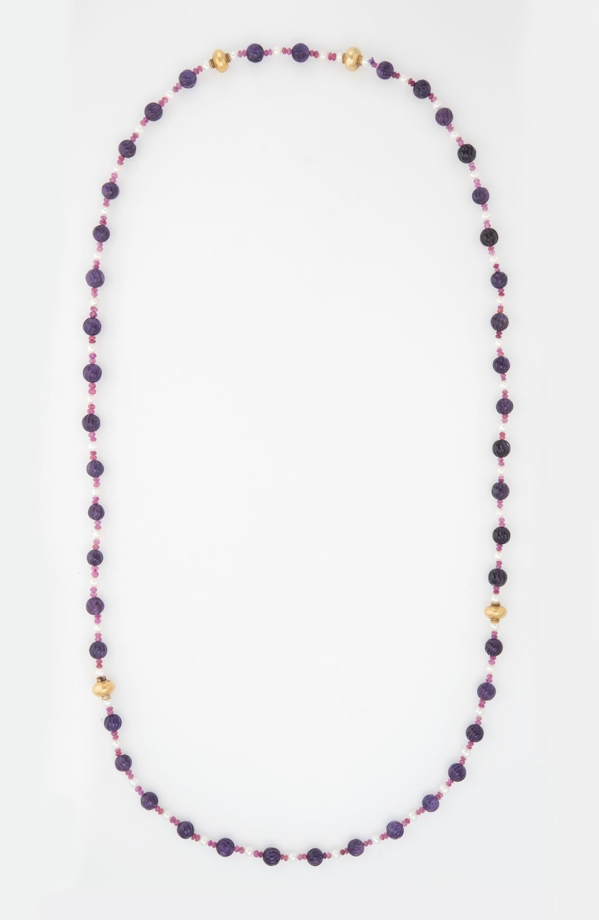 Finely detailed vintage multi gemstone necklace with 14 karat yellow gold bead separators.  

Fluted amethyst beads each measure 9.5mm. The rough cut ruby beads measure (average) 3.5mm. The cultured pearls measure (average) 5mm. The stones are in