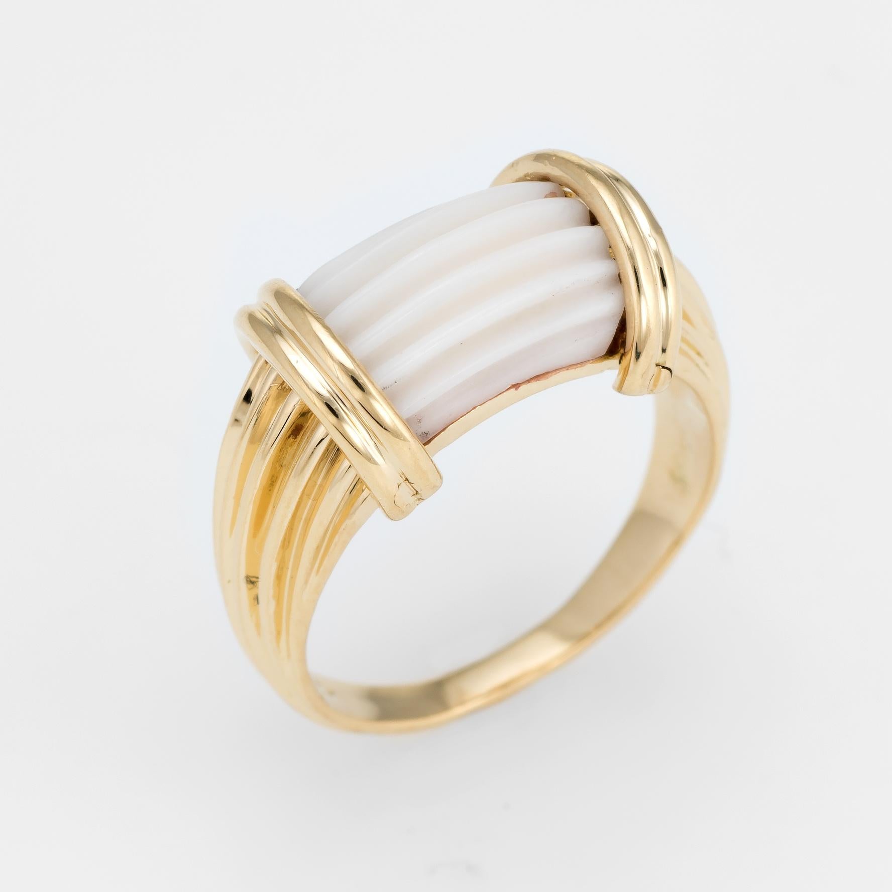Finely detailed vintage white coral ring (circa 1960s to 1970s), crafted in 14 karat white gold. 

White coral is fluted and set flush into the mount. The coral is in excellent condition and free of cracks or chips.   

The side shoulders feature