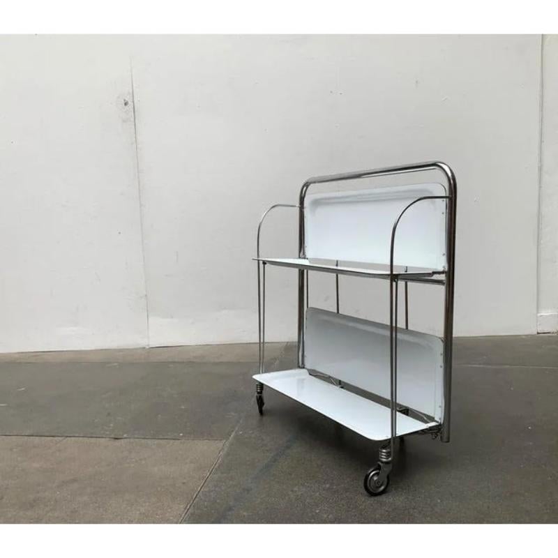 Classic mid century dinett serving car in the rare color white.

A particularly functional furniture. Perfect for the home bar or as a side table. The car is foldable and is particularly easy to stow. This piece has an attribution mark.

Additional