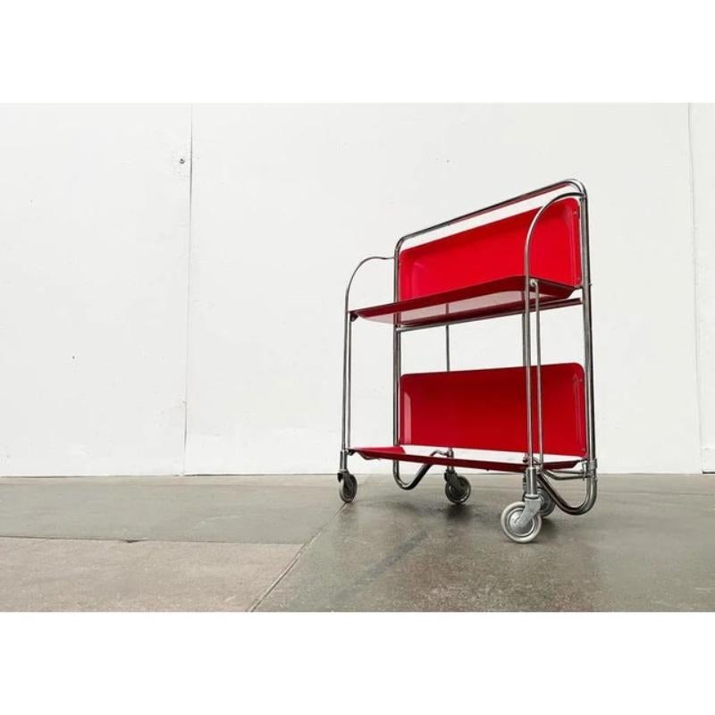 Classic mid century dinett serving car in the rare color red and particularly good condition.

A particularly functional furniture. Perfect for the home bar or as a side table. The car is foldable and is particularly easy to stow.

Additional