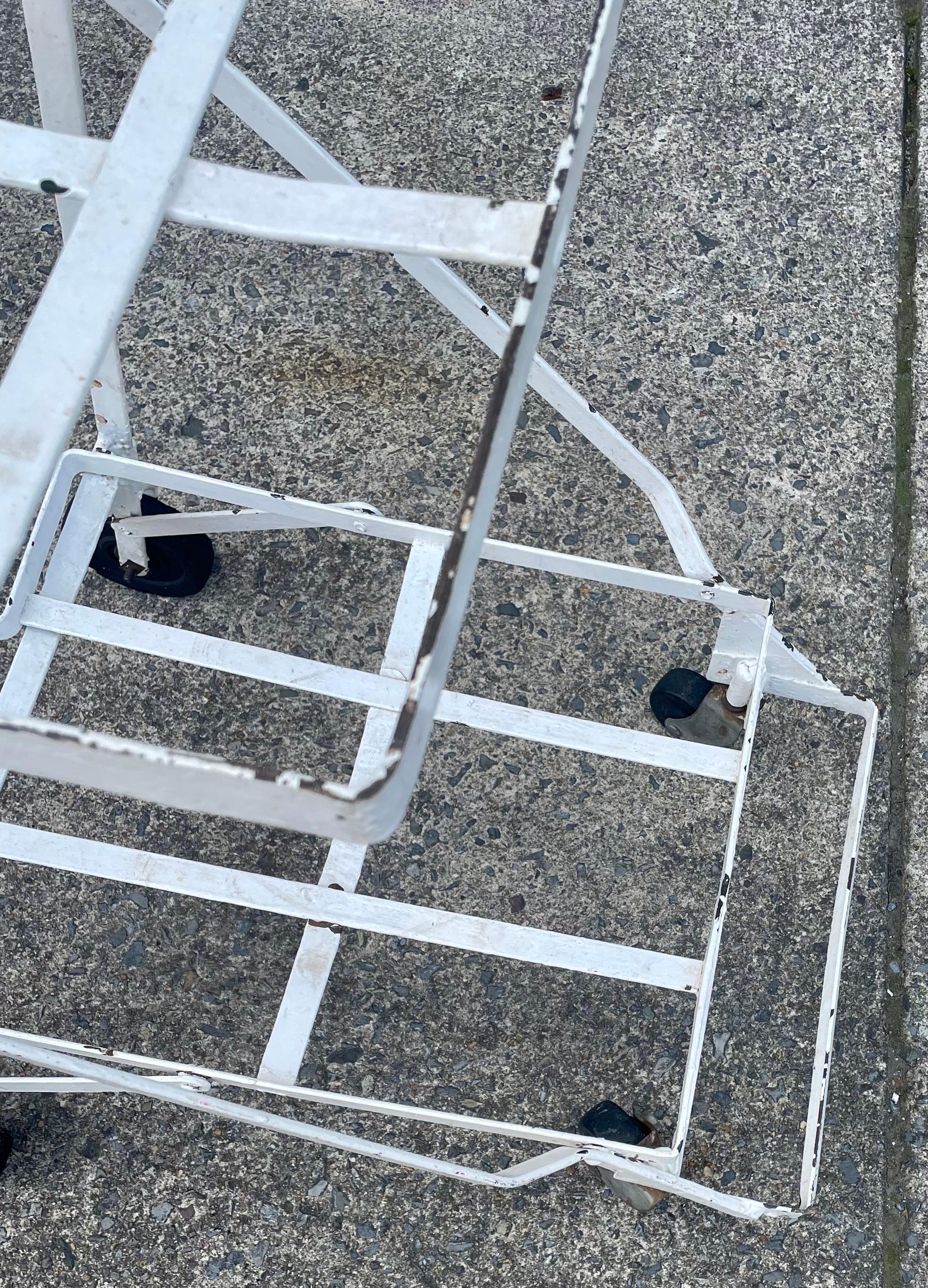 This is a really fun fold up shopping cart from a mid century grocery store that would have held two wire baskets and I can think of so many creative uses for it! It would be wonderful in a garden with vines and flowers but it will have a longer
