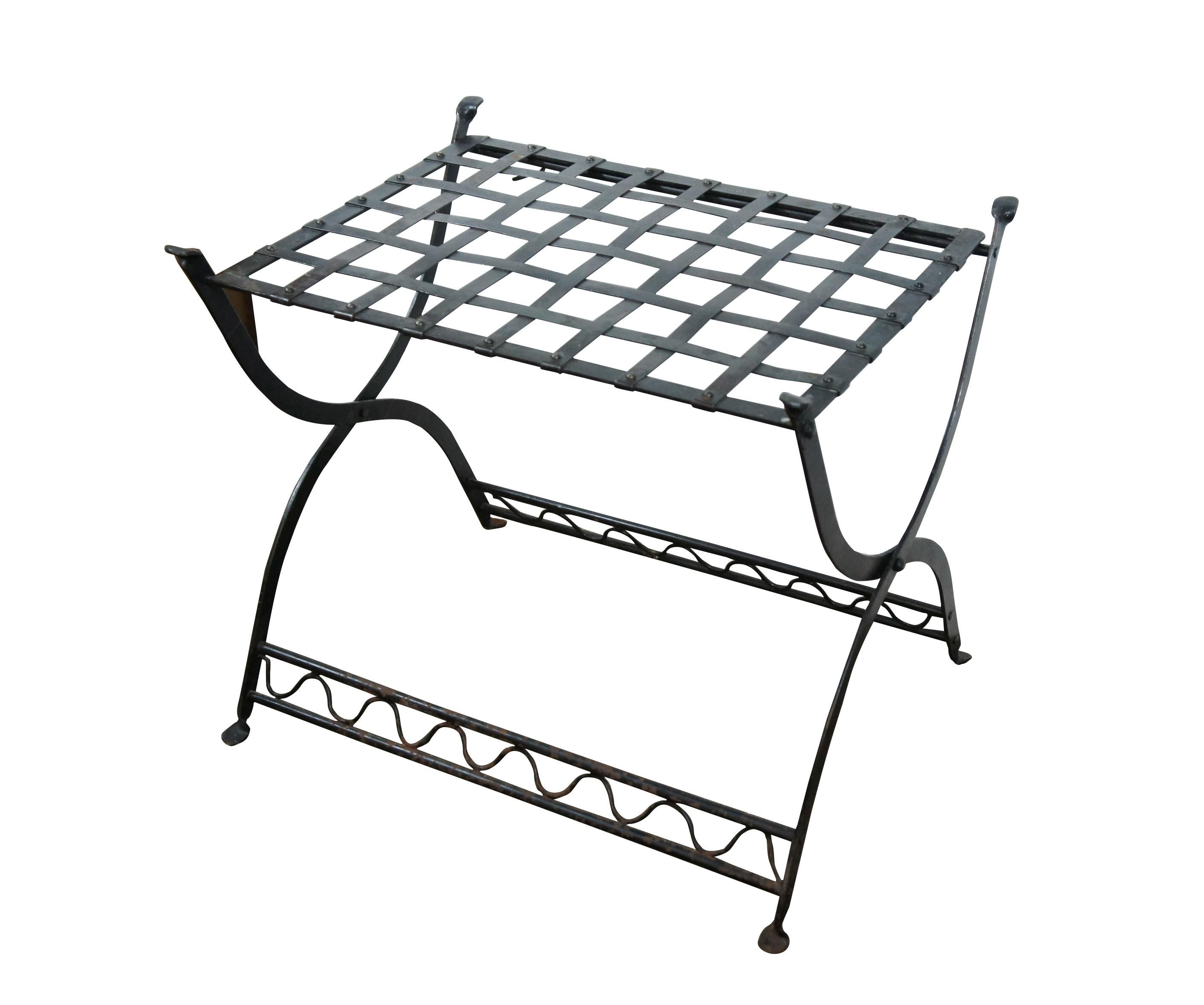 Late 20th century folding iron stand / bench / side table / luggage rack. Curule style legs with wave patterned stretchers, rectangular woven basket weave top.

Dimensions:
25