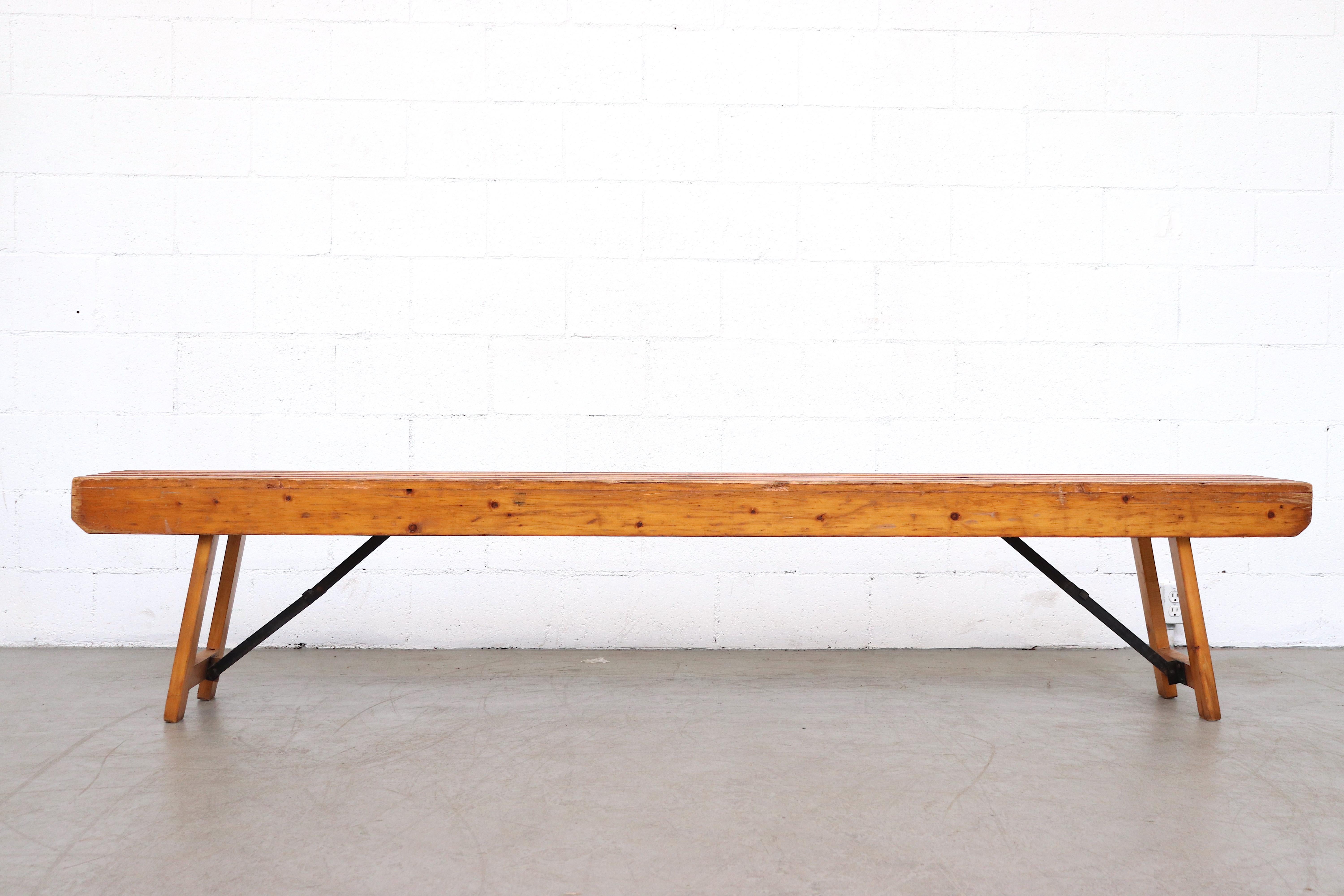 Excellent vintage folding wood slat bench from a Dutch post office. Beautiful patina. In original condition with some visible signs of wear consistent with age and use. 3 available in varying degrees of wear.