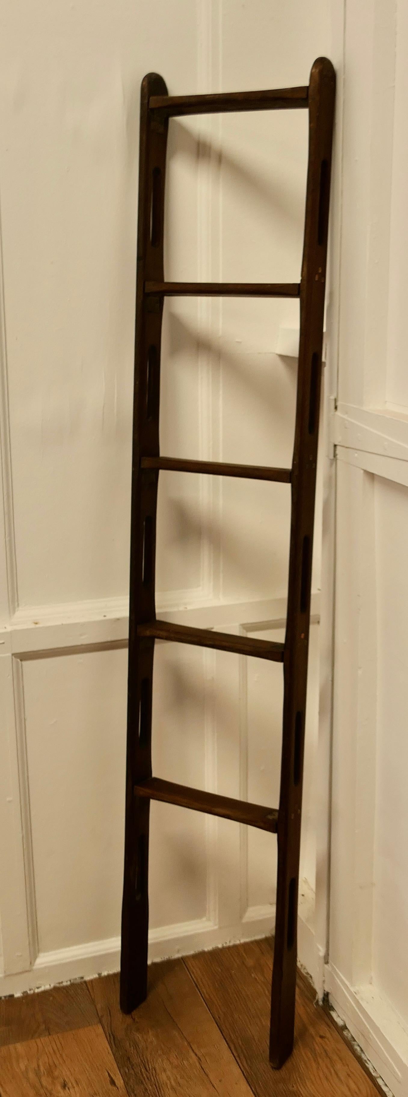 Vintage Folding Teak and Brass Yacht Ladder

A superb stowable piece in excellent antique condition
In quality thick solid teak with copper rivets and brass hinges
Solidly made and robust with 5 treads
When opened out the ladder is 66” tall, 13”