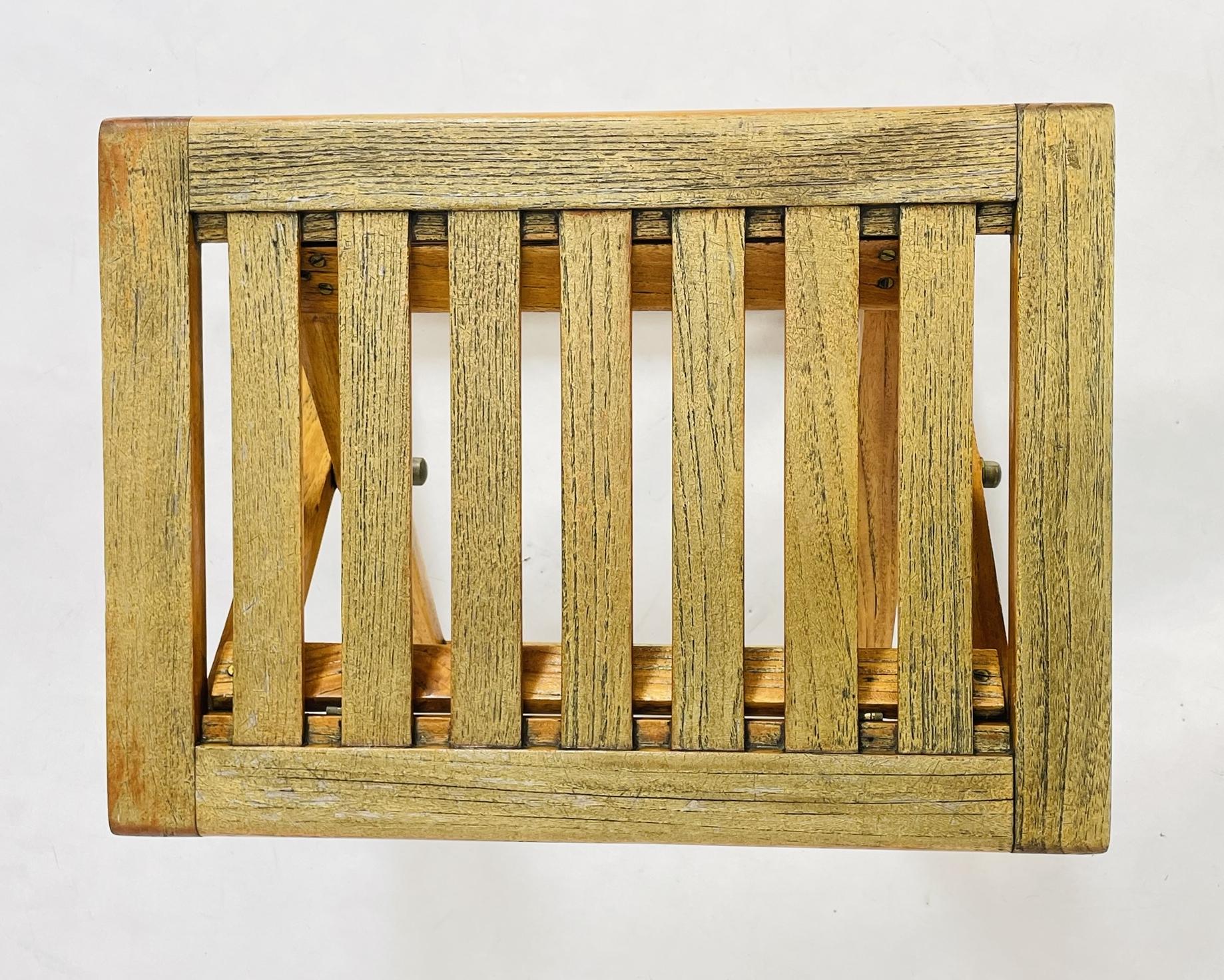 Vintage folding teak stool designed and manufactured by Summit Furniture, renowned for their high-quality teak furnishings. This versatile piece features a slatted teak top, warm natural patina, and a functional folding design for easy storage and