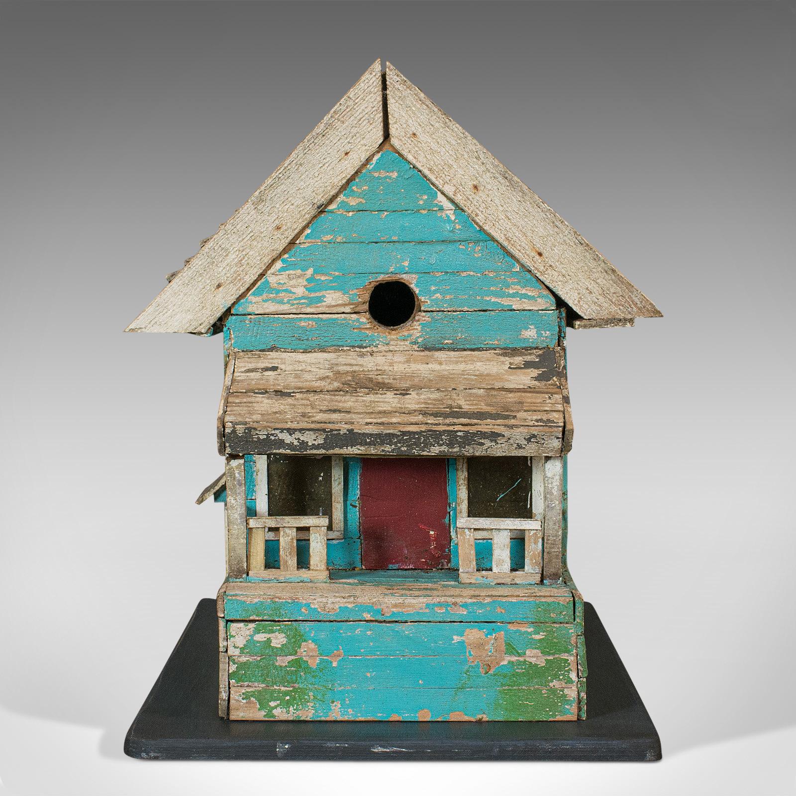 This is a vintage folk art birdhouse. An American, scratch built pine twin bird house with a distinctly midwestern folksy taste, dating to the mid-20th century, circa 1960.

A little birdhouse for your soul
Displays a desirable aged patina
Hand