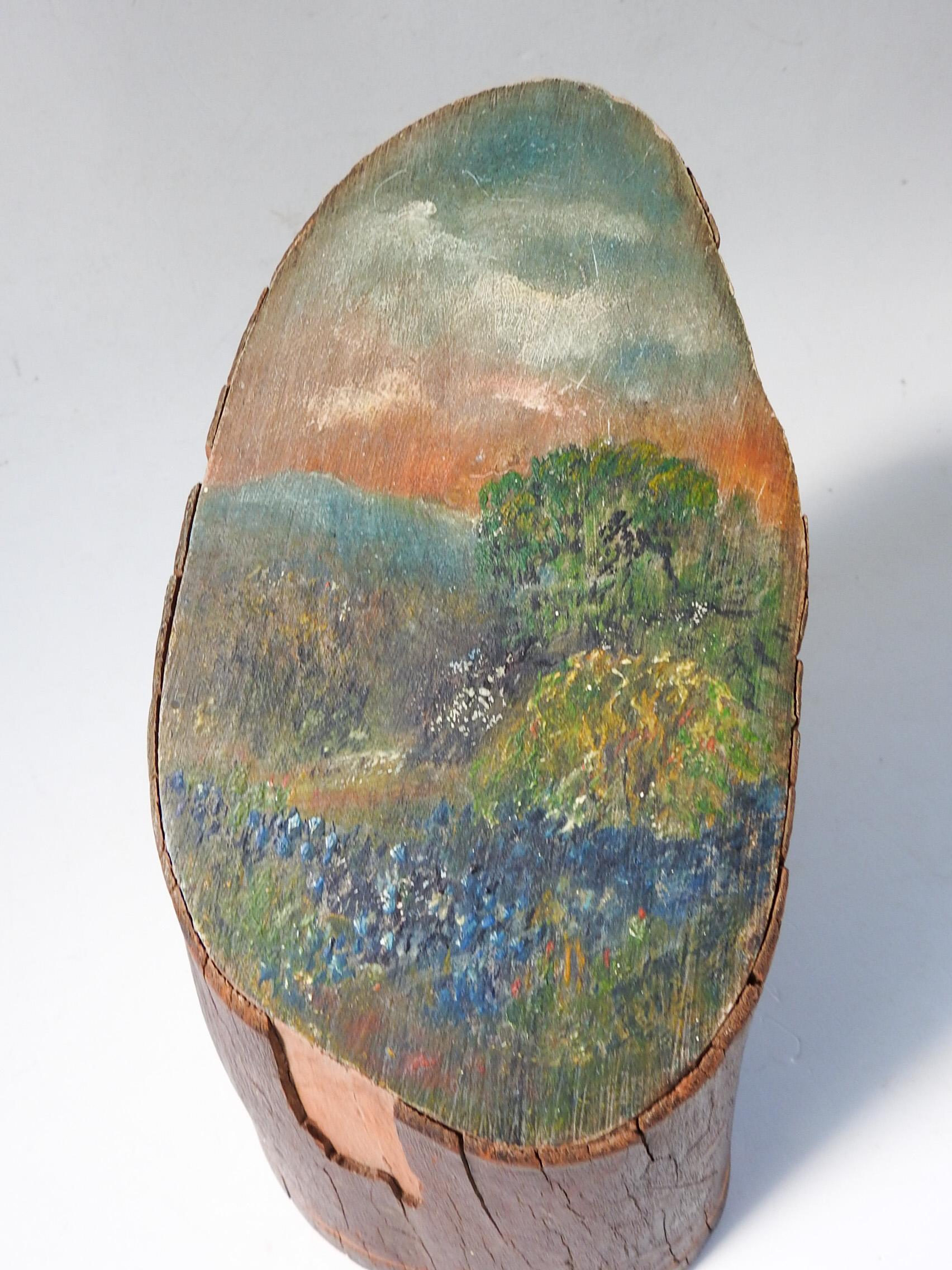 Circa 1930's bluebonnet painting on a piece of wood trunk. Unsigned, some bark missing, scratches to wood, painting in good condition, darkened with age. Painted surface is 5