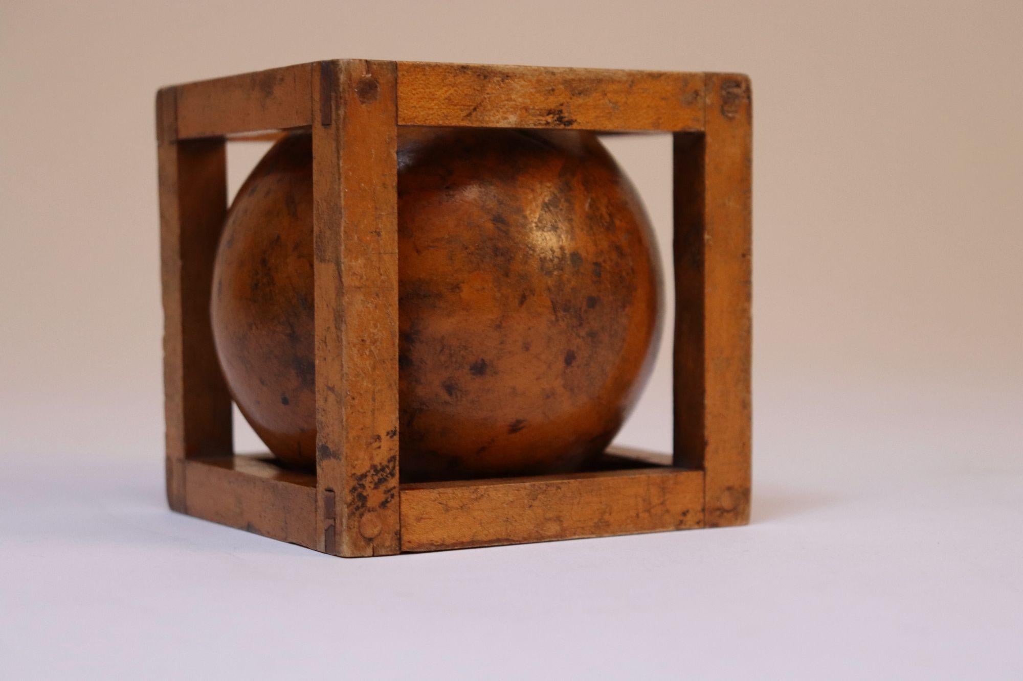 Vintage whimsy composed of a sphere within a framed cage (ca. 1930s, USA).
Expertly carved and constructed with details like finger-joints to ensure durability.
Good age/rich patina as shown (scuffs, darkening, general, age-commensurate