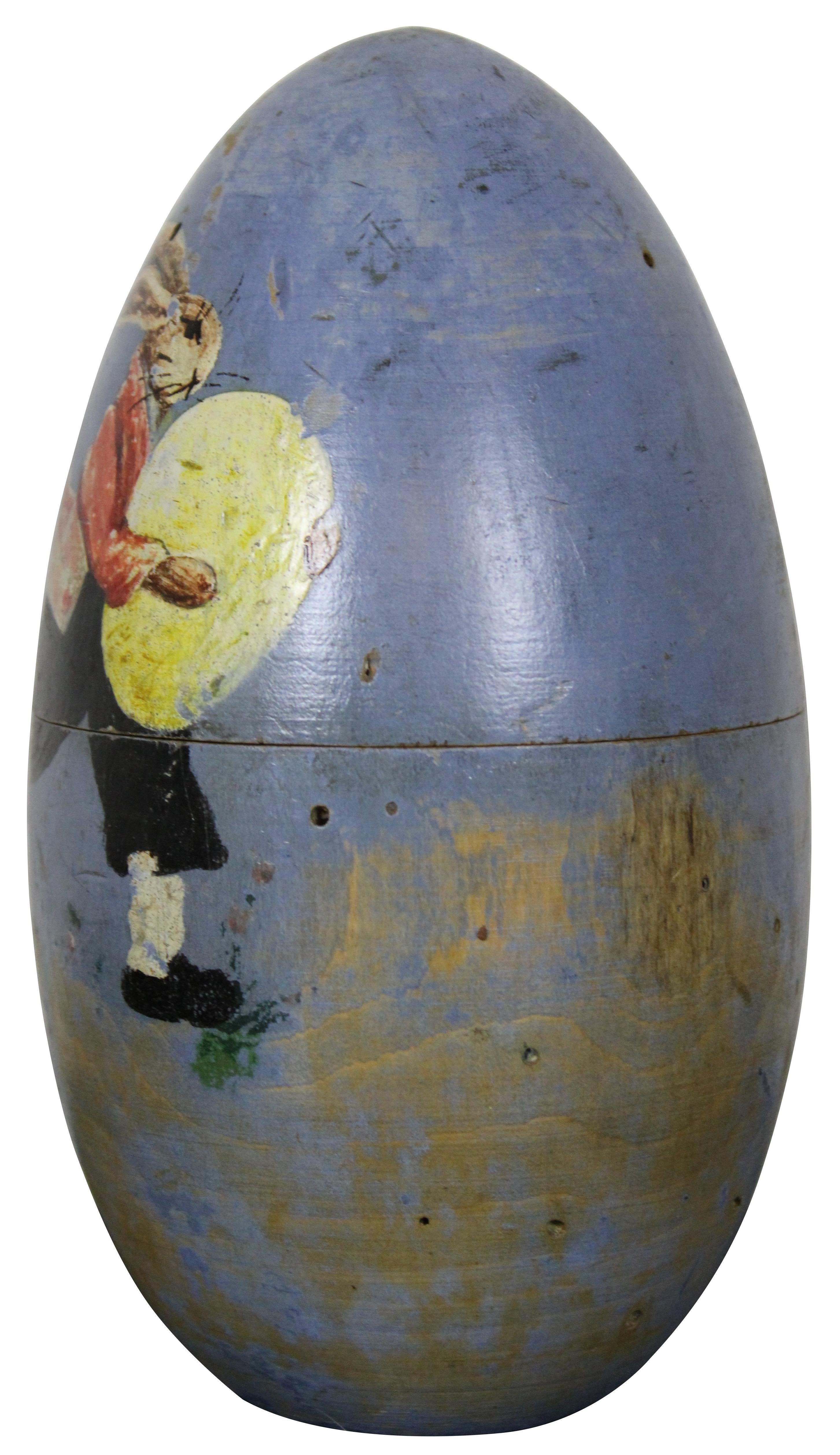 Vintage folk art style carved wooden egg shaped trinet box, painted blue with the image of an Easter Bunny running with a large yellow egg. Measure: 8