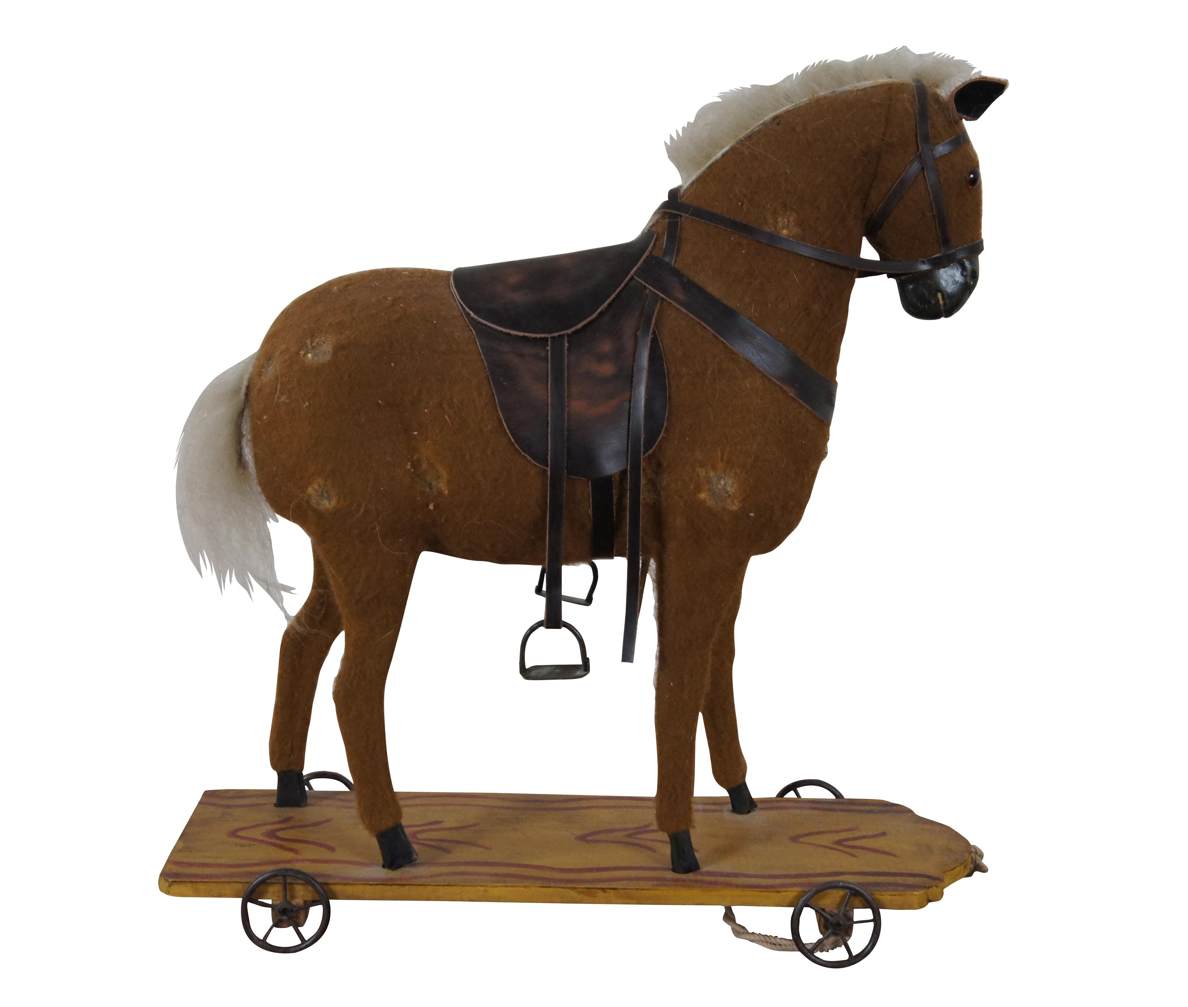 Vintage folk art pull toy featuring a felt horse on wood cart

DIMENSIONS
14.5” x 5” x 15” (Width x Depth x Height)