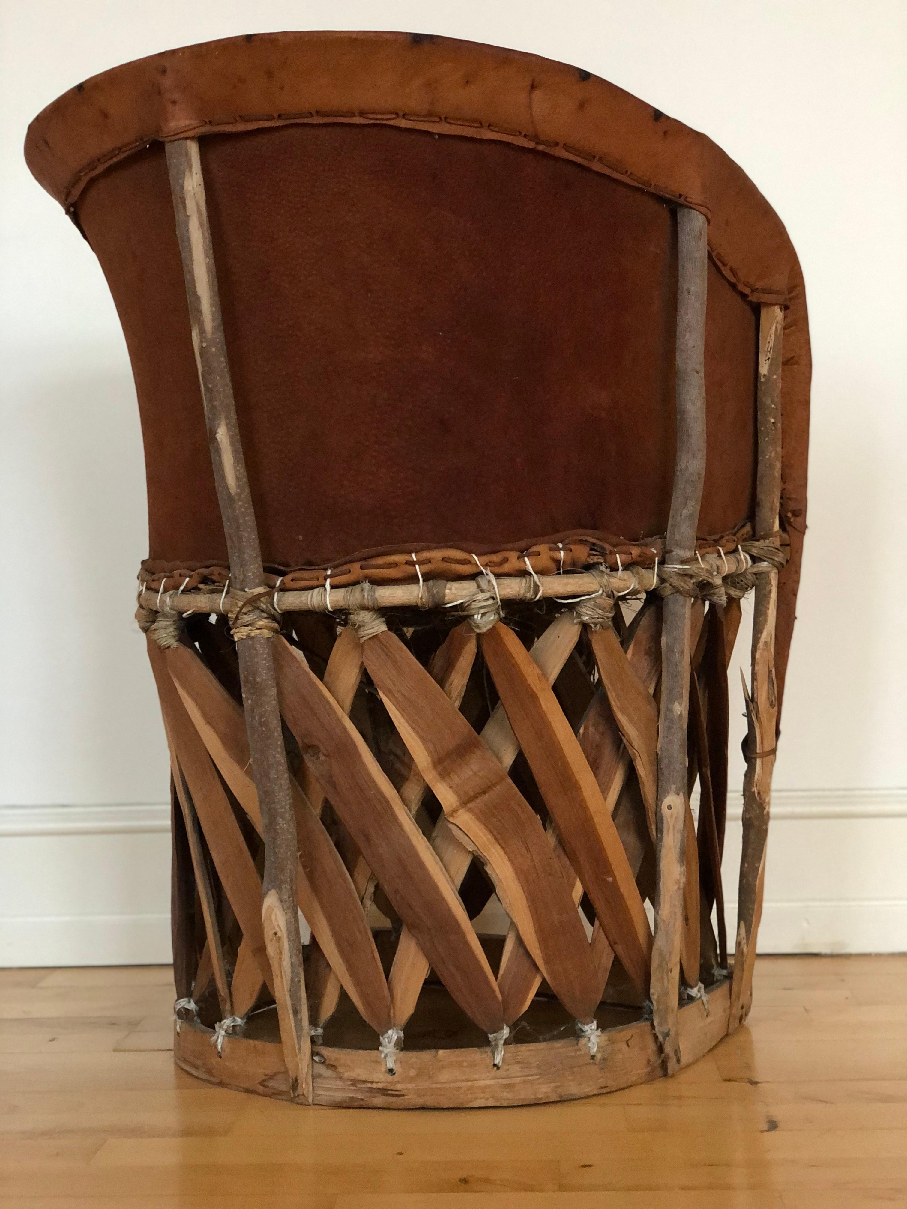 This unique Folk Art leather chair, crafted by Equipale in Mexico during the 1970s, features an exotic woven wooden frame covered in luxurious ostrich leather. Completely handmade, it reflects the craftsmanship and traditional design of Mexican