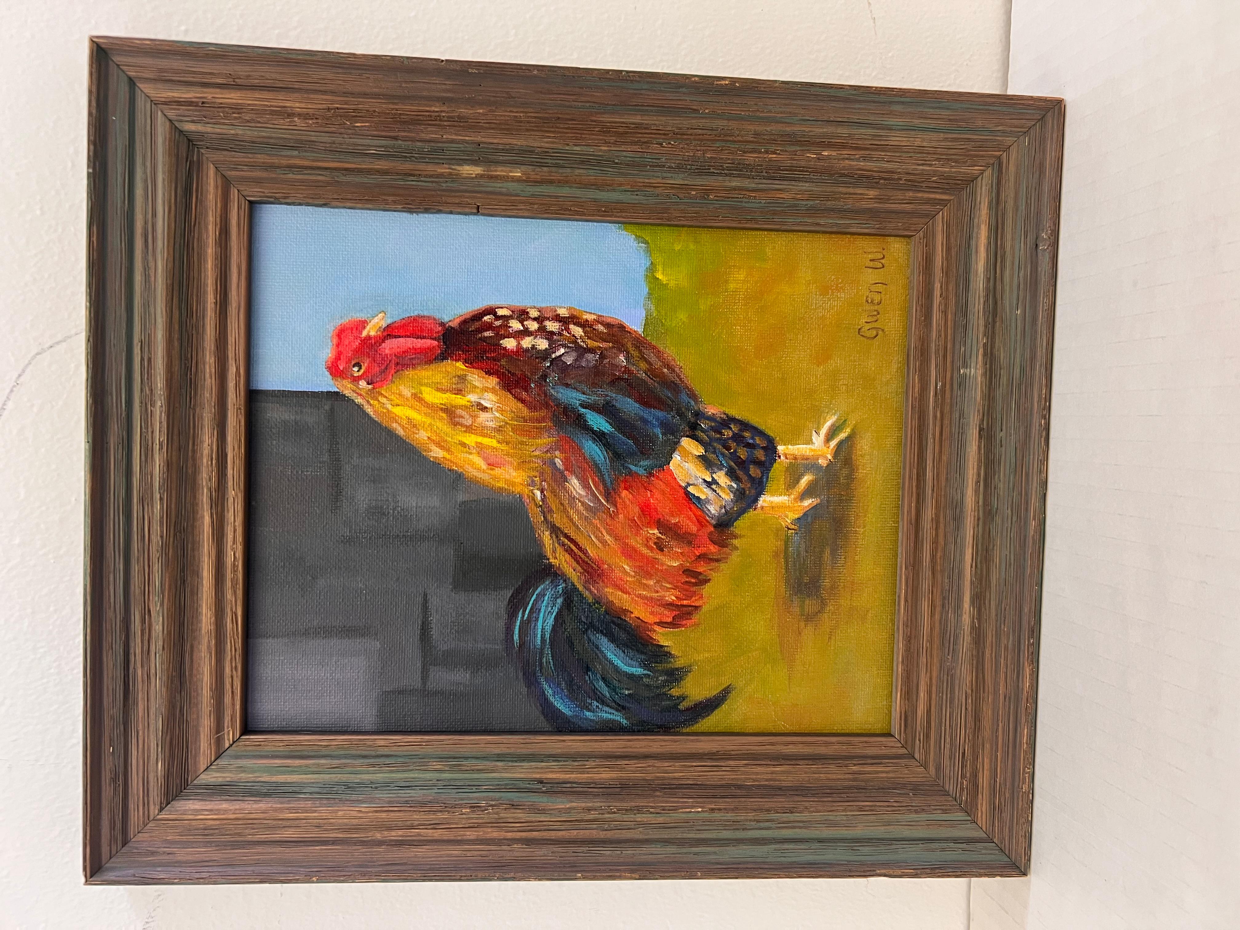 El cuadro representa un colorido gallo de pie en un entorno vibrante, caracterizado por pinceladas audaces y una paleta de colores vivos que incluye rojos, amarillos y azules. El estilo se inclina hacia un enfoque más impresionista o folclórico,