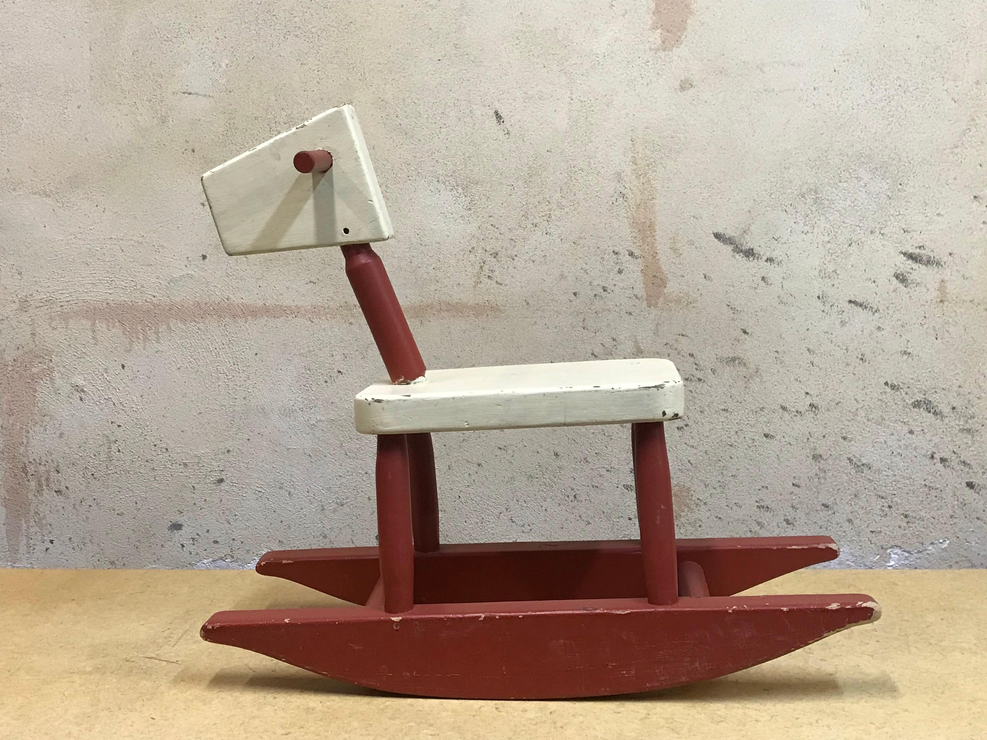 Very cool vintage mid-century children's rocking horse, handmade, circa 1955 with a Bauhaus aesthetic. 
Well constructed, old paint, well functioning, very sculptural and usable as a toy.