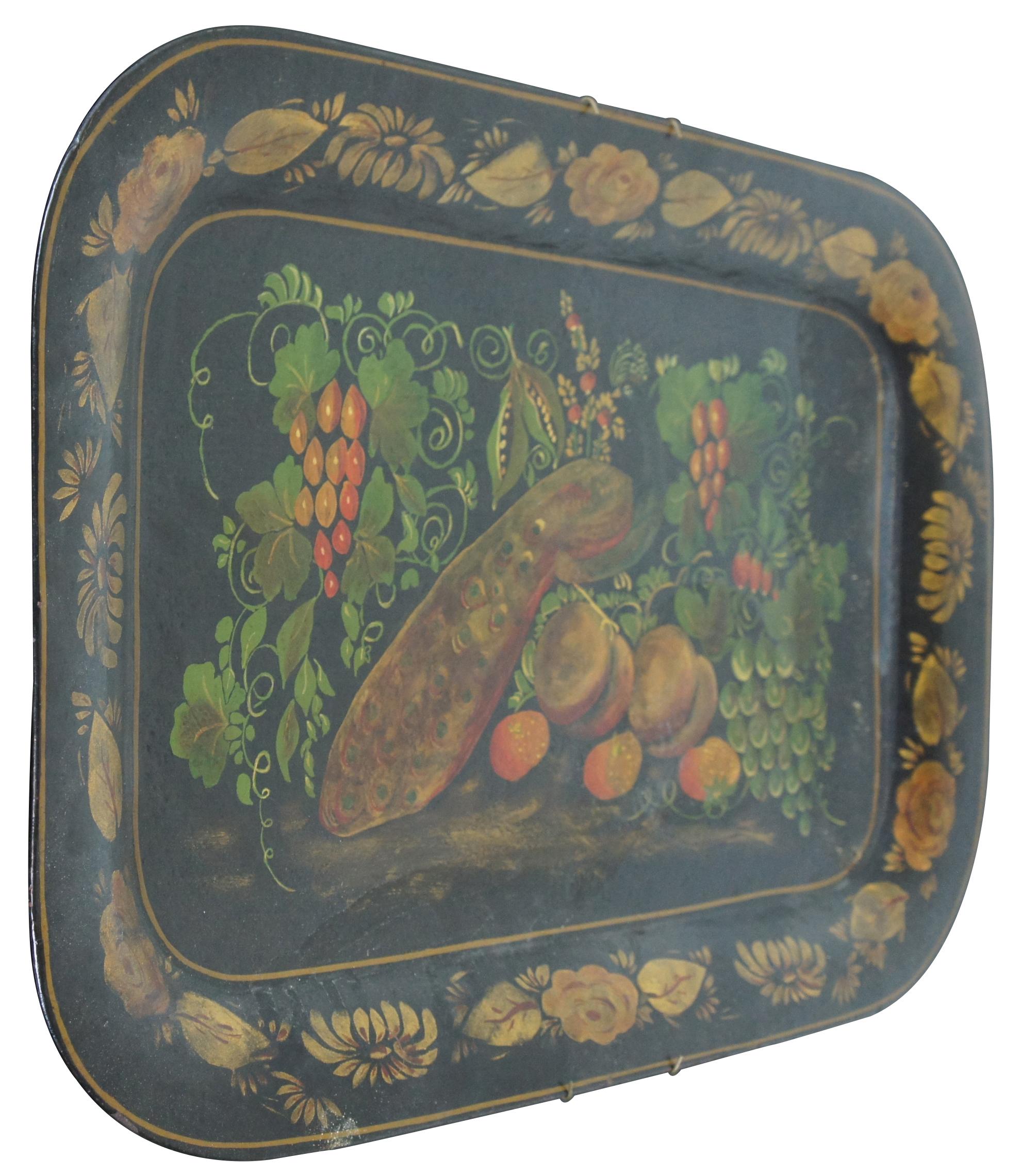 Large Americana Folk Art toleware tray, hand painted in black with gold floral border and a still life of a peacock (bird) surrounded by fruit. Includes bracket for hanging on the wall. Measures: 24”.
   