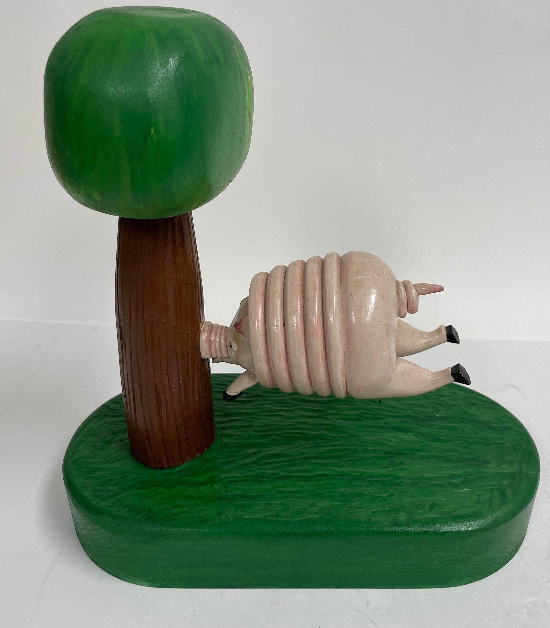 Vintage Folk Art Wood Sculpture of a Pig running into a Tree by R Harper 1991
This piece is a handcrafted wooden sculpture by artist R Harper signed and dated 4-91.
This one of a kind flying pig sculpture is made of solid wood and had been