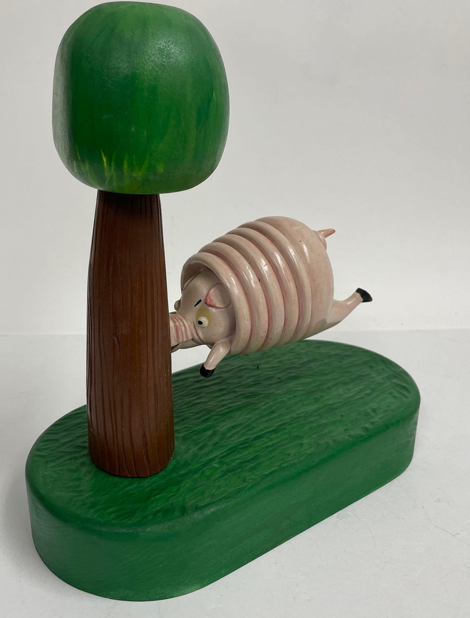 Hand-Crafted Vintage Folk Art Wood Sculpture of a Pig Running into a Tree by R. Harper 1991 For Sale