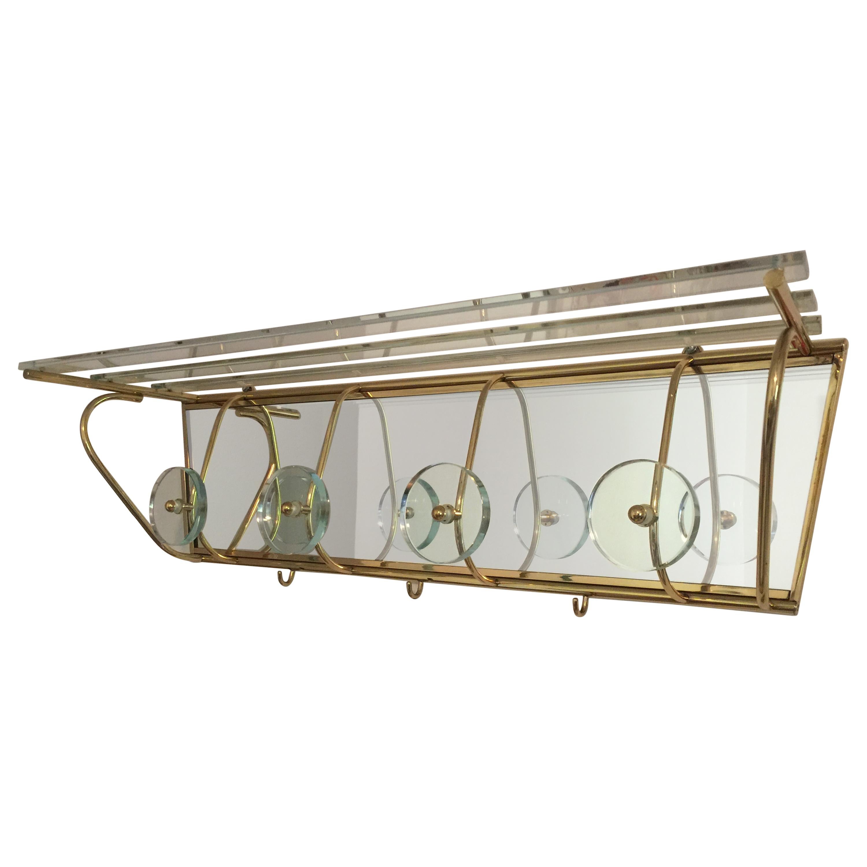 This is the largest mirrored coat rack in the style of Fontana Arte with glass and brass. Features 4 original glass discs to hang coats, the rack above for hats and 3 brass hooks for scarves.