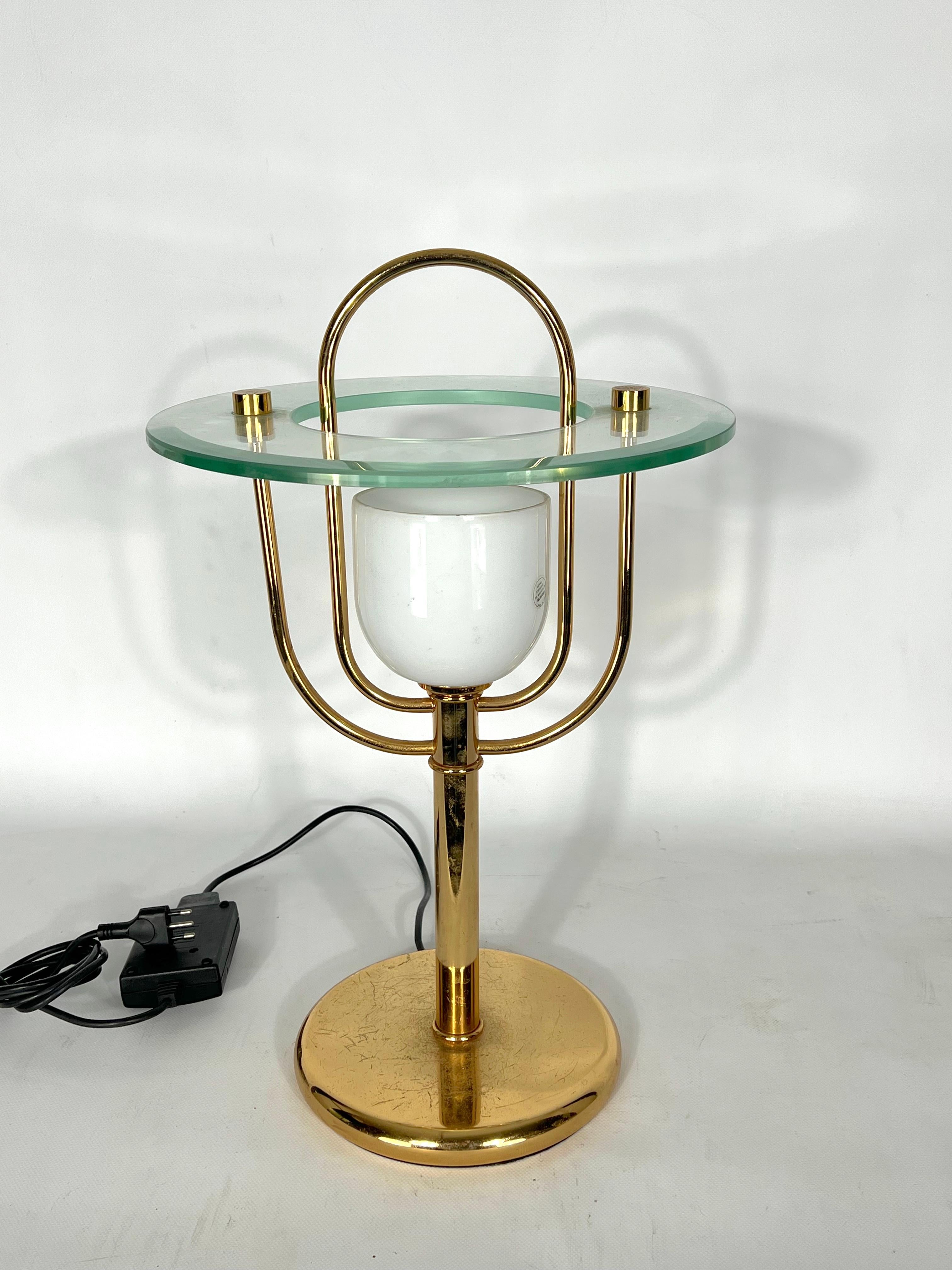 Good vintage condition with trace of age and use. No cracks or chips. Made from brass, clear thick glass and milk murano glass. Reminiscent of Fontana Arte style. Produced in Italy during the 70s. Full working with EU standard, adaptable on demand
