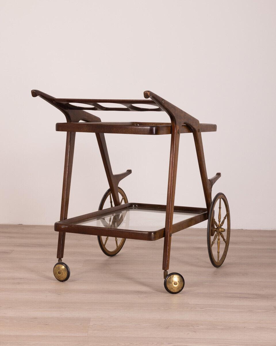 Food trolley in wood and gilt brass inserts, with two glass shelves with bottle holder, design Cesare Lacca, 1950s.

Conditions: In good condition, working, it shows signs of wear from time.

Dimensions: Height 74 cm; Width 52 cm; Length 80
