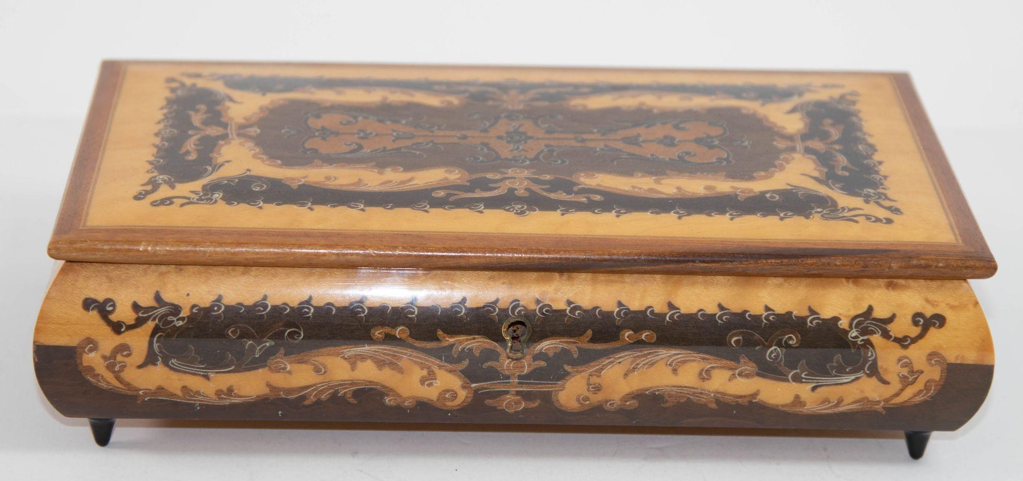 Elegant vintage large footed Brown color wooden music box with top finely hand painted and inlaid with foliages floral decor.
Upon opening, the music box begins to play 