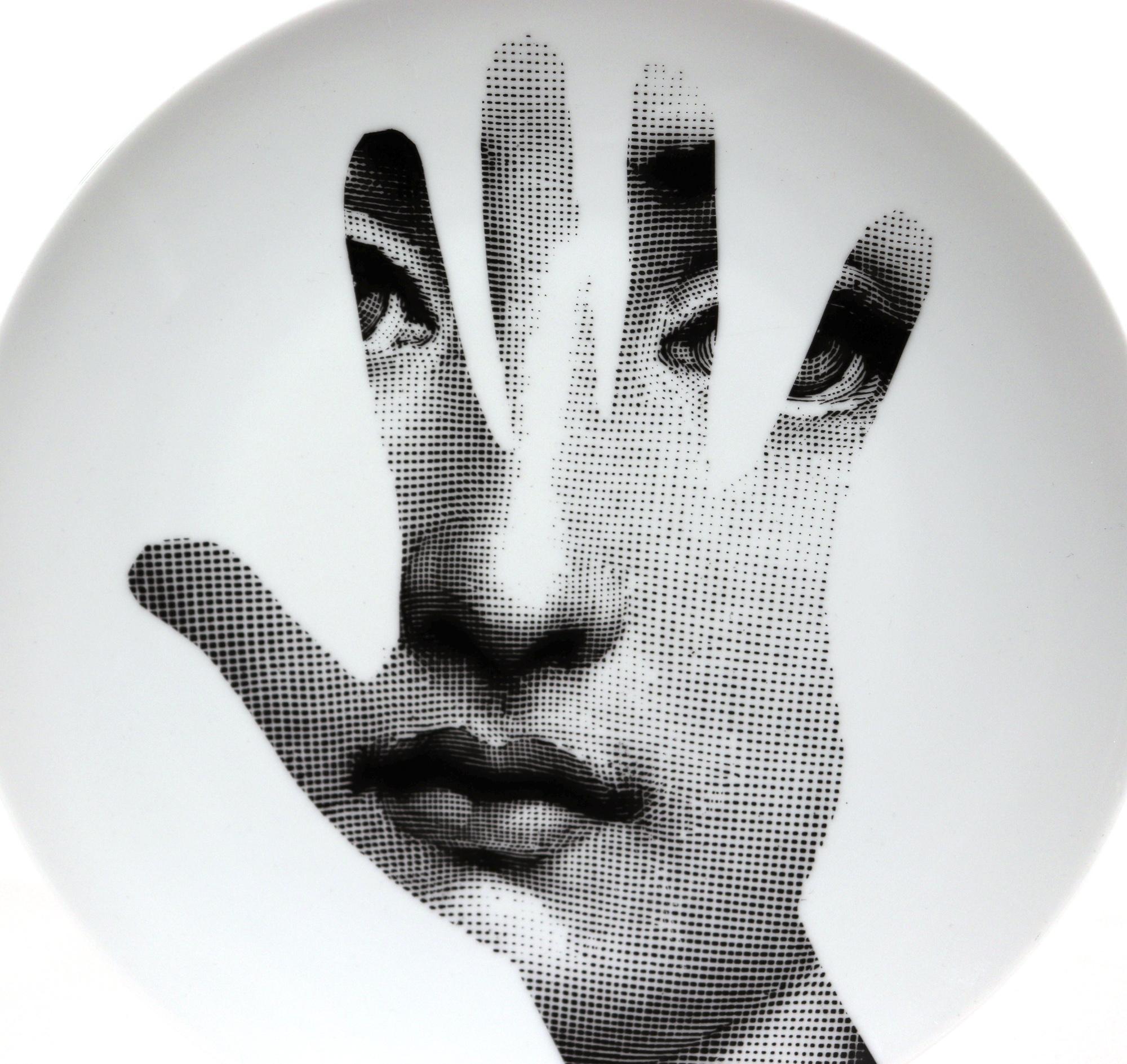 Vintage Fornasetti porcelain themes & variation plate #15,
The Hand,
Barnaba Fornasetti, Fornasetti Studio.

The Surreal Fornasetti porcelain plate in the Themes & Variation pattern depicts the face of Lina Cavalieri, Piero Fornasetti's muse