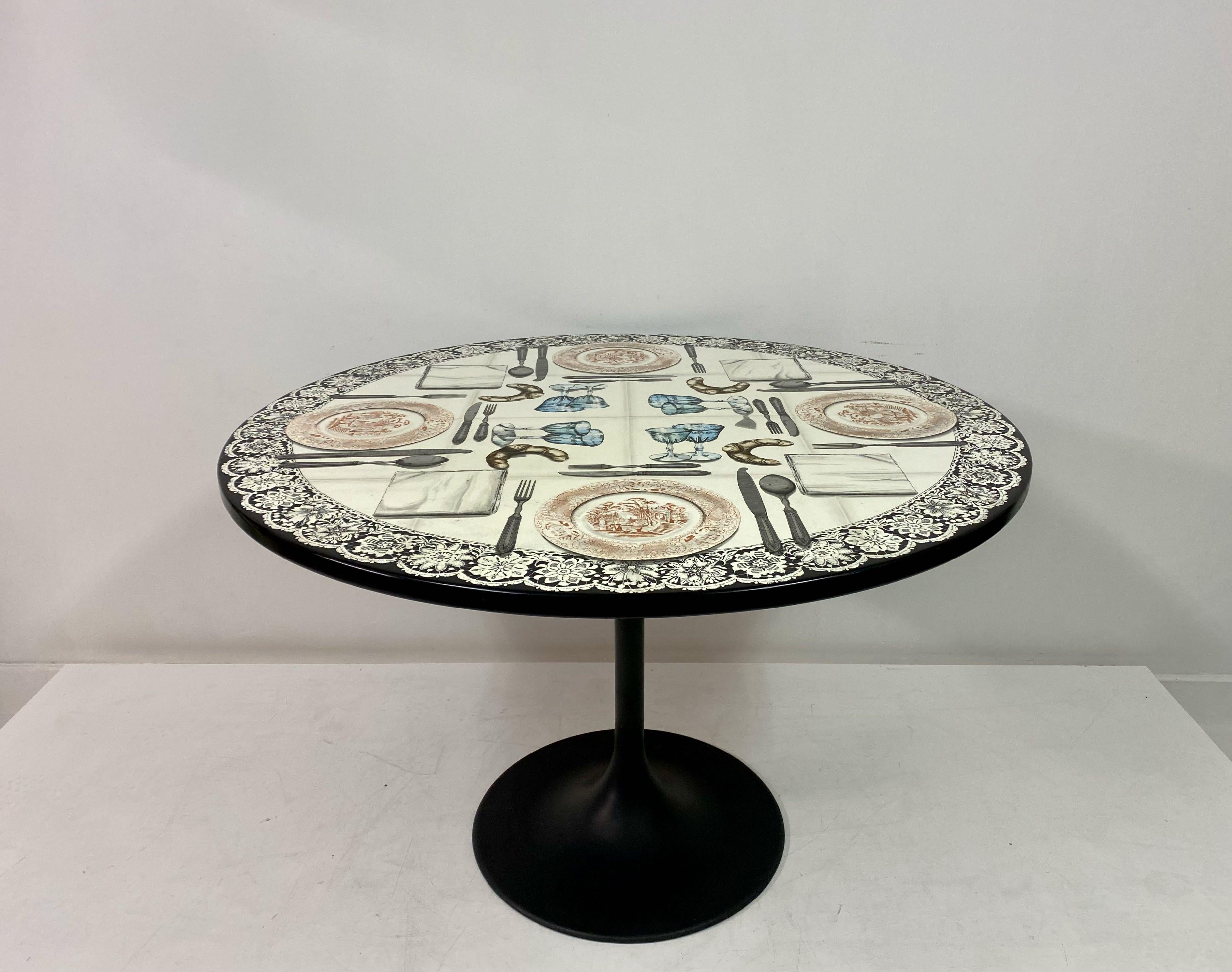 Dining or centre table

By Piero Fornasetti

Lithographically printed top

Silvered cutlery

Black powder coated base

Signed on top

Italy 20th century.
 