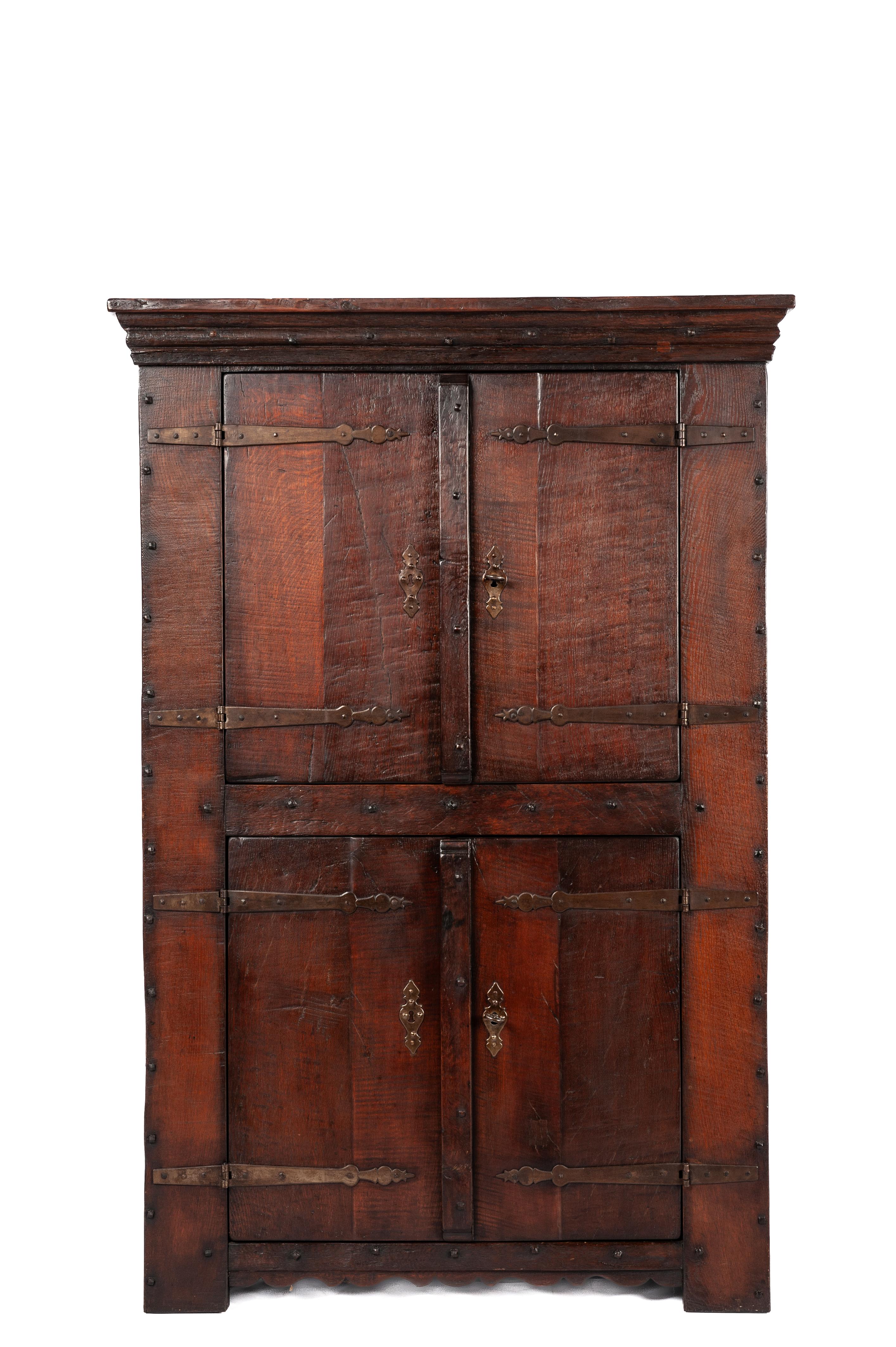 On offer here is a distinguished four-door oak cupboard, meticulously crafted from reclaimed oak wood dating back to the 1960s. This unique piece was built by the esteemed Piet Rombouts & Sons furniture workshop, a legacy proudly continued by our