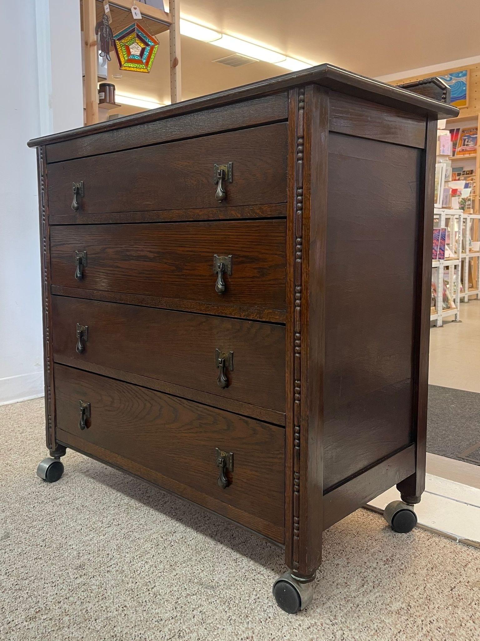 Mid-Century Modern Vintage Four Drawer Dresser on Casters With Carved Wood Detailing. For Sale