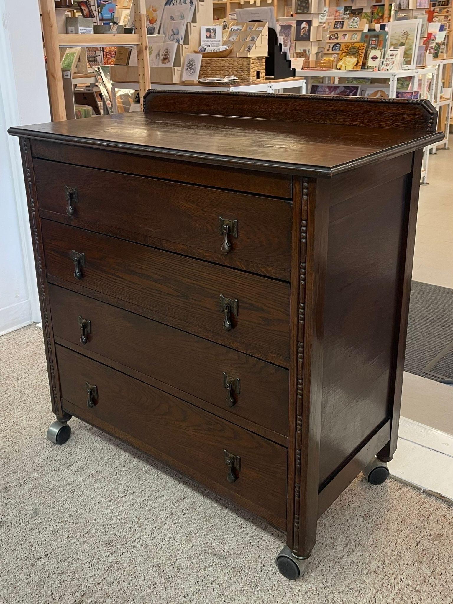 Late 20th Century Vintage Four Drawer Dresser on Casters With Carved Wood Detailing. For Sale
