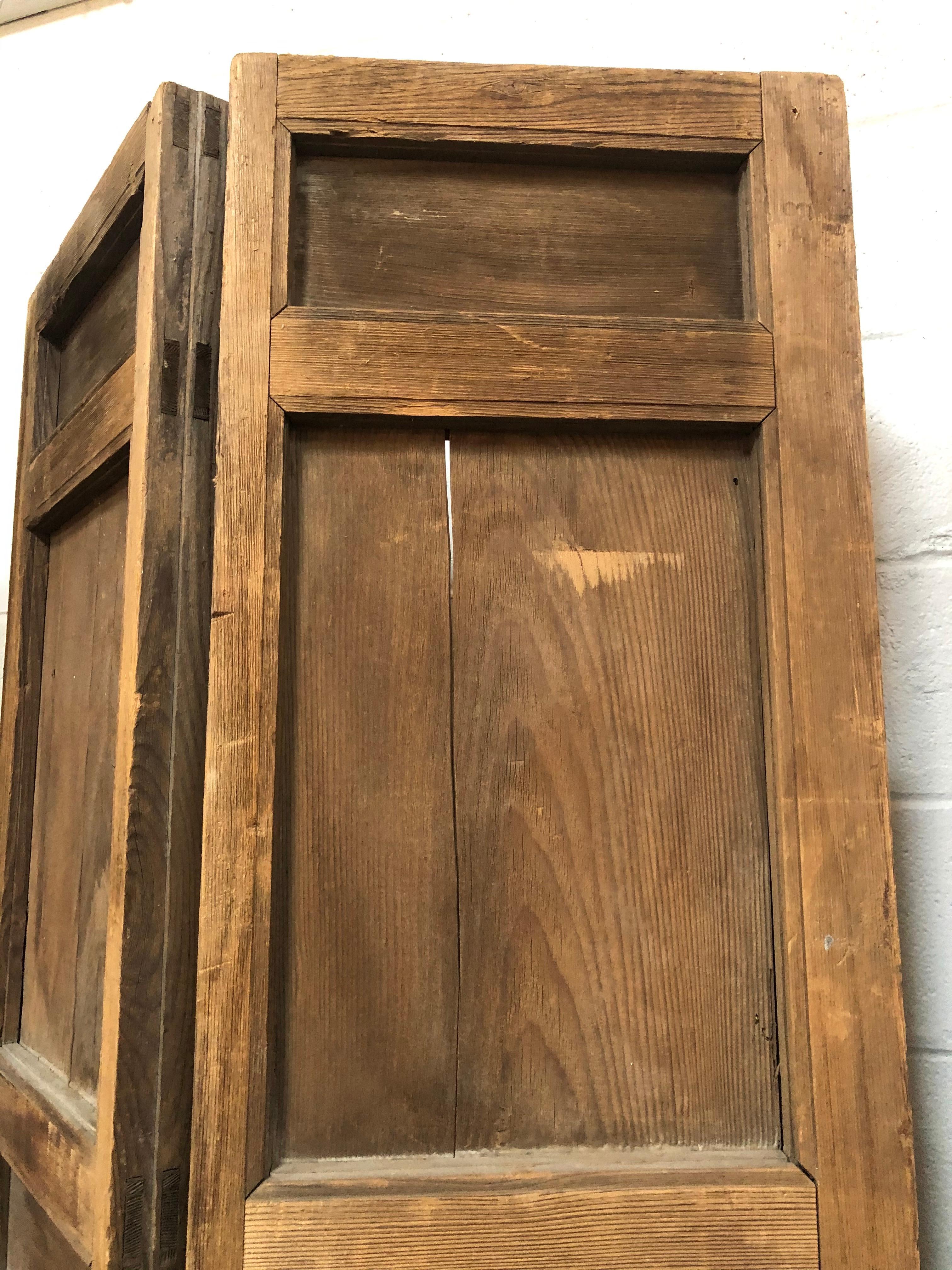 Vintage four panel wood screen would look amazing as a room divider, accent wall piece, garden entryway, or to hang plants on both inside or outside. Has original iron handles and fastening. Grain is shown in wood finish. Heavy enough to stand alone
