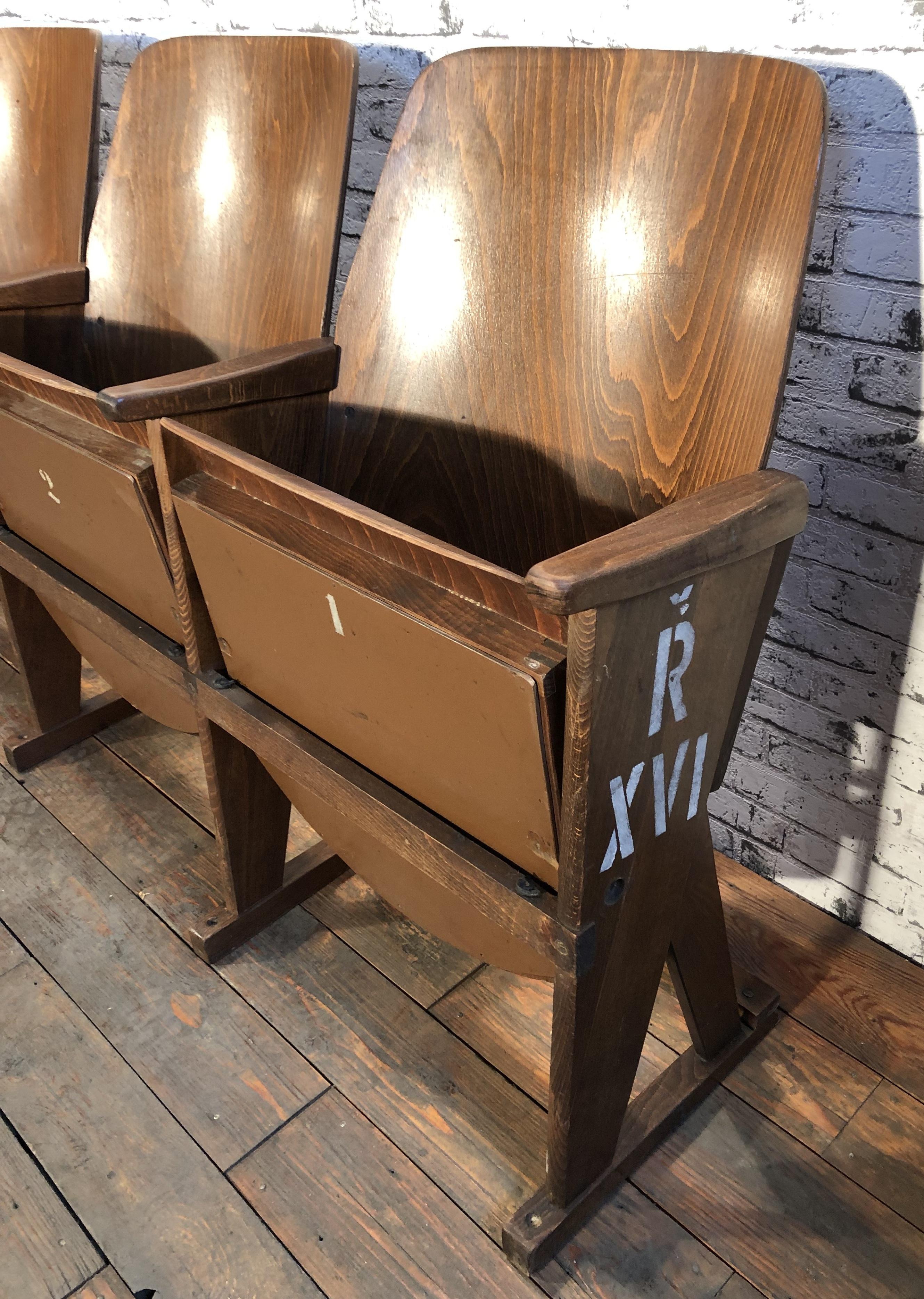 This four-seat cinema bench was produced by Ton (former Thonet) in Czechoslovakia during the 1960s. The chairs are stable and can be placed anywhere. It is completely made of wood (partly solid wood, partly plywood). The seats fold upwards. The