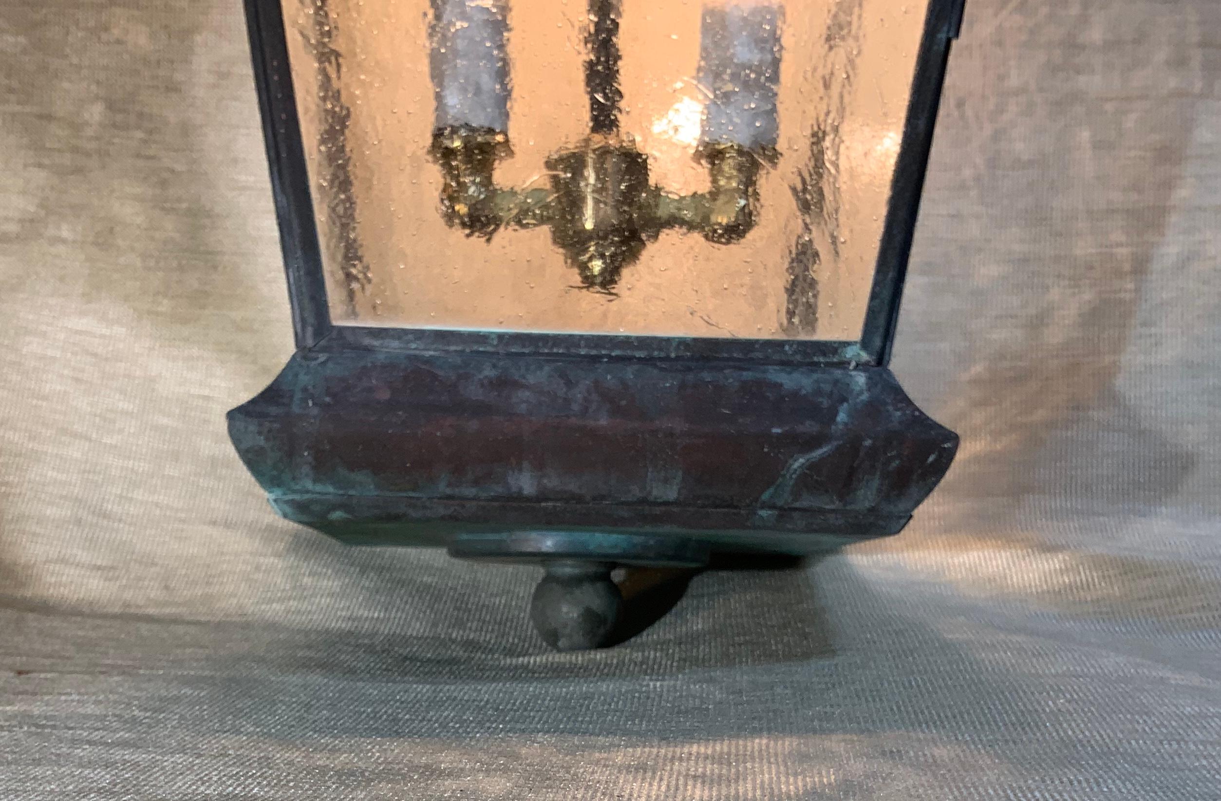Elegant four sides hanging lantern made of solid brass with, seeded glass, and two 60/watt lights.
Ready to use, brass canopy included.