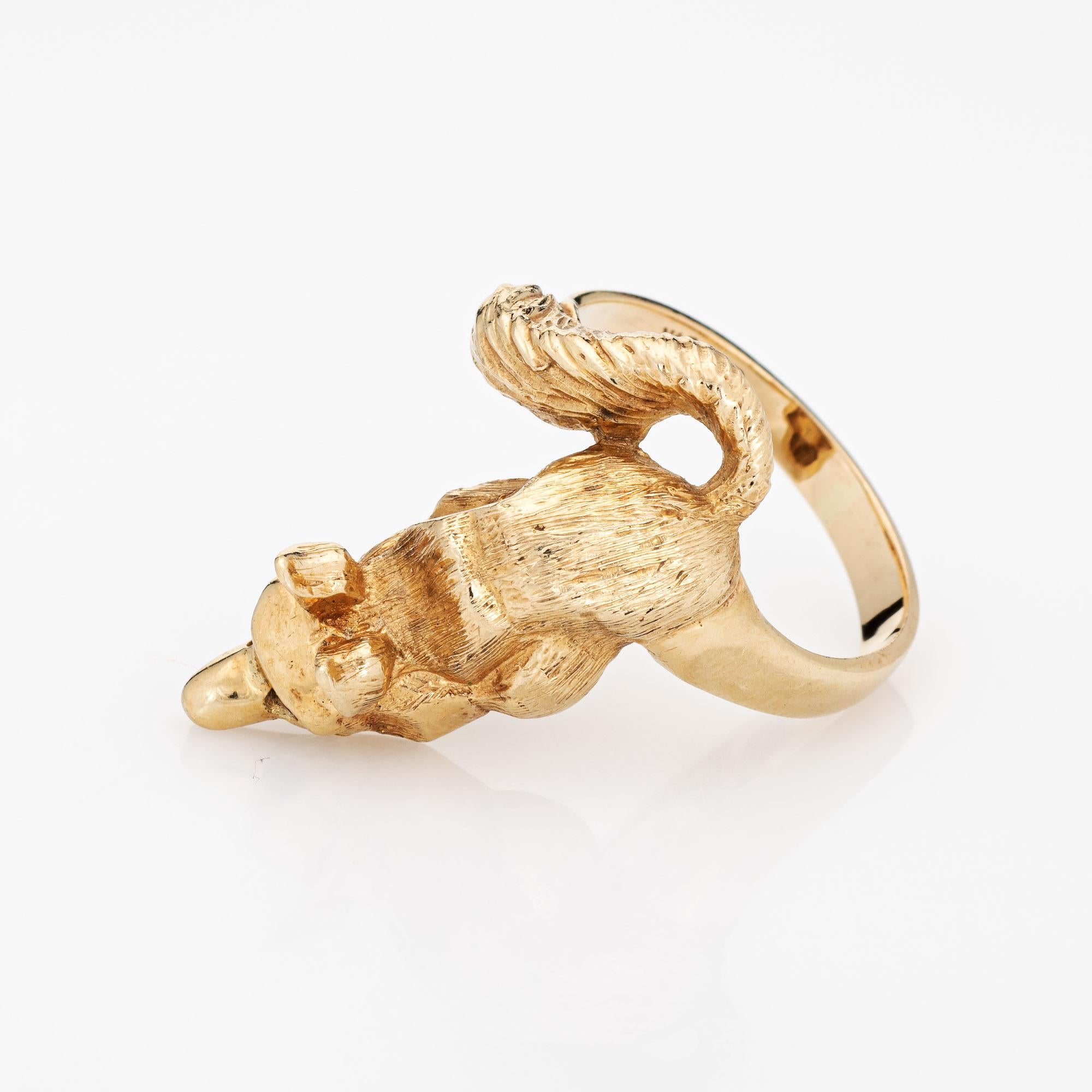 Stylish vintage fox ring (circa 1960s to 1970s) crafted in 14 karat yellow gold. 

Two rubies are set into the eyes and total an estimated 0.02 carats. 

The beautifully detailed fox is designed to lay on your finger, as if to pounce. The tail coils