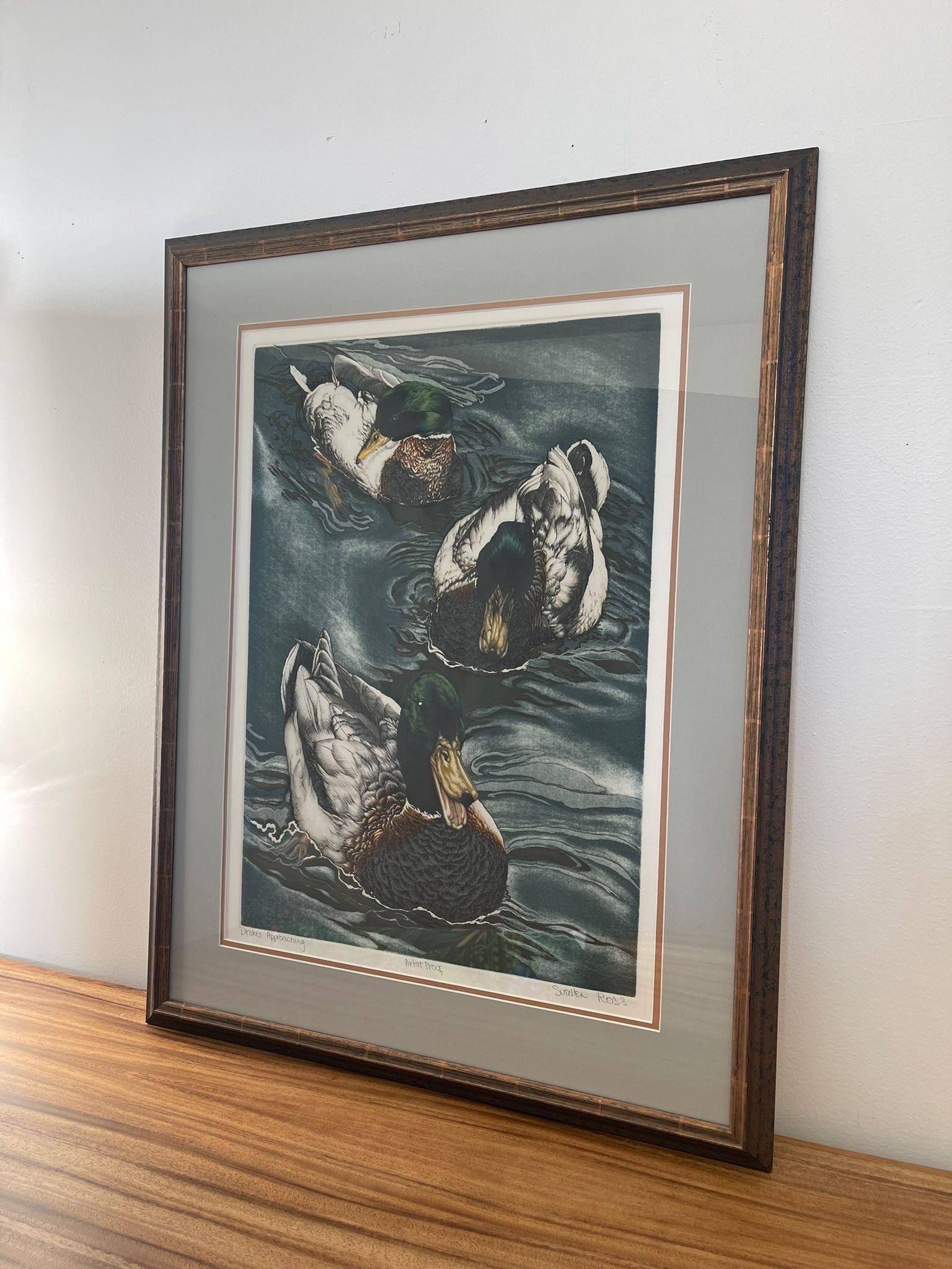 This Art print is an Artist proof, which is notably made under direct supervision of the Artist and approved before numbered prints were made. This Piece of Art features mallards swimming through water. Professionally framed and matted. Vintage
