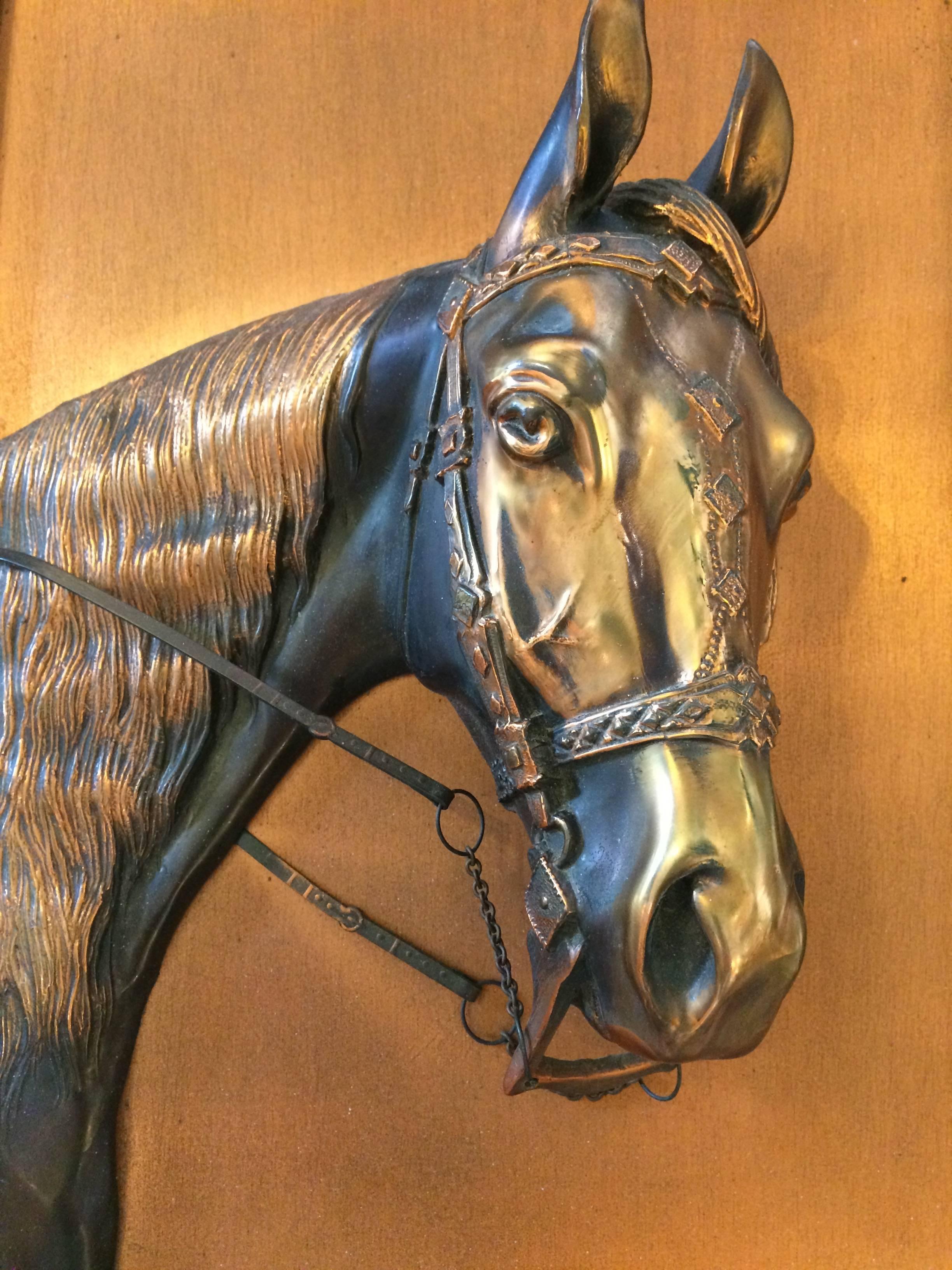 Wonderfully warm piece of art having an impressive cast copper horse head in relief, set against smooth copper background and framed in a rich oak frame.