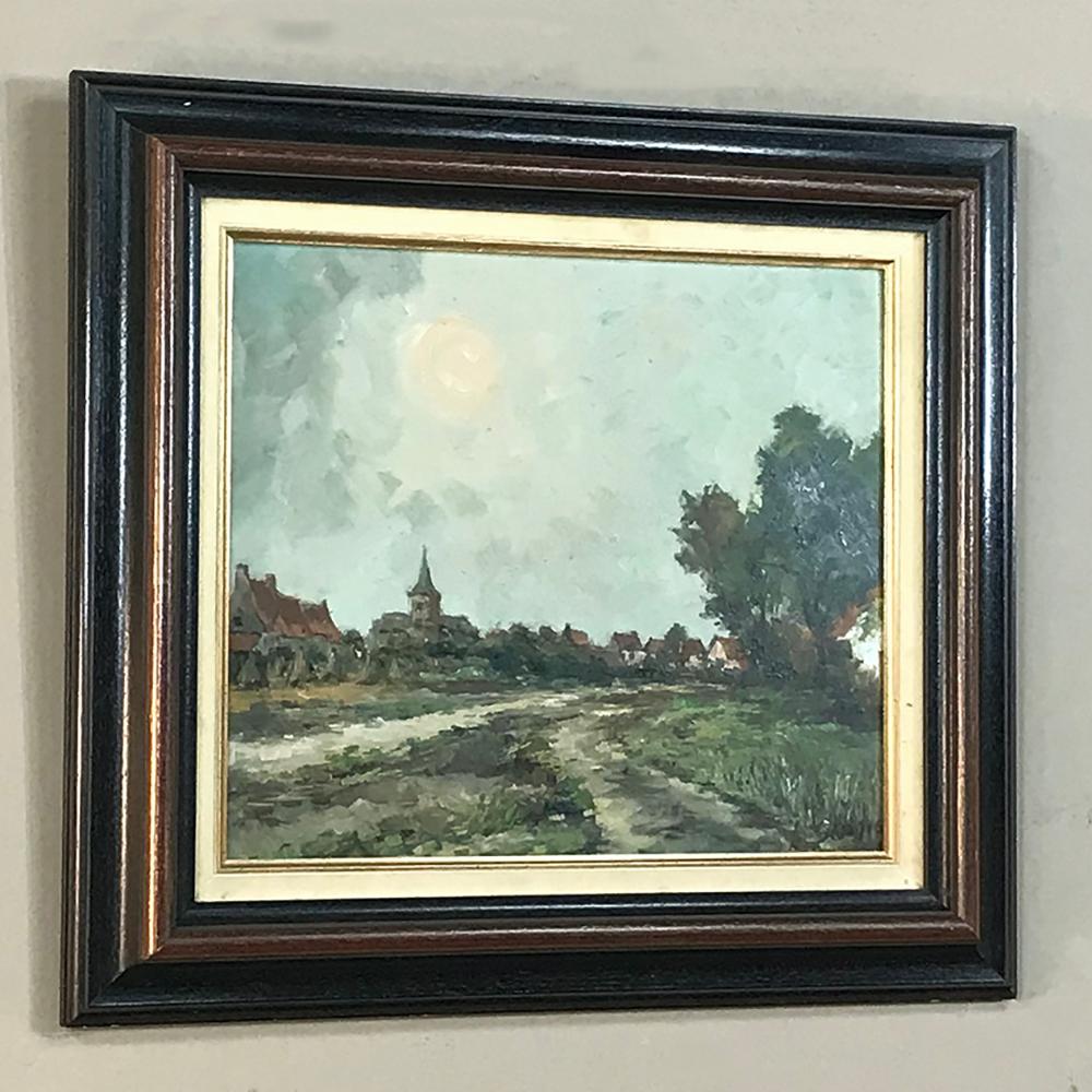 Vintage framed oil painting on board by A. Sergier is a lovely impressionistic pastoral with a cityscape in the background, depicting a quaint Flemish village with a dirt road inviting the viewer into the scene to explore the environs. Wonderful