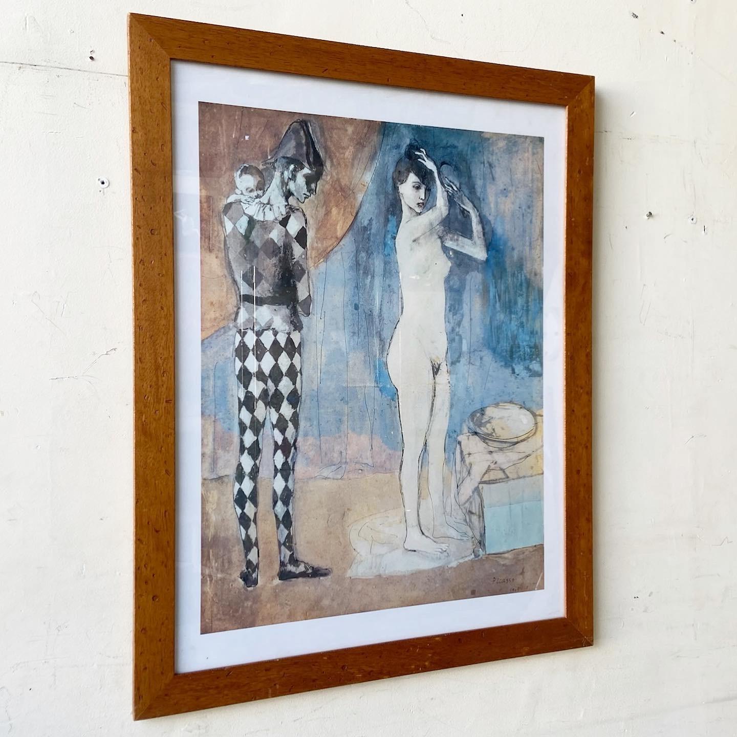 Exceptional vintage framed Picasso print titled “Harlequin’s Family”. Features a wooden frame.
 