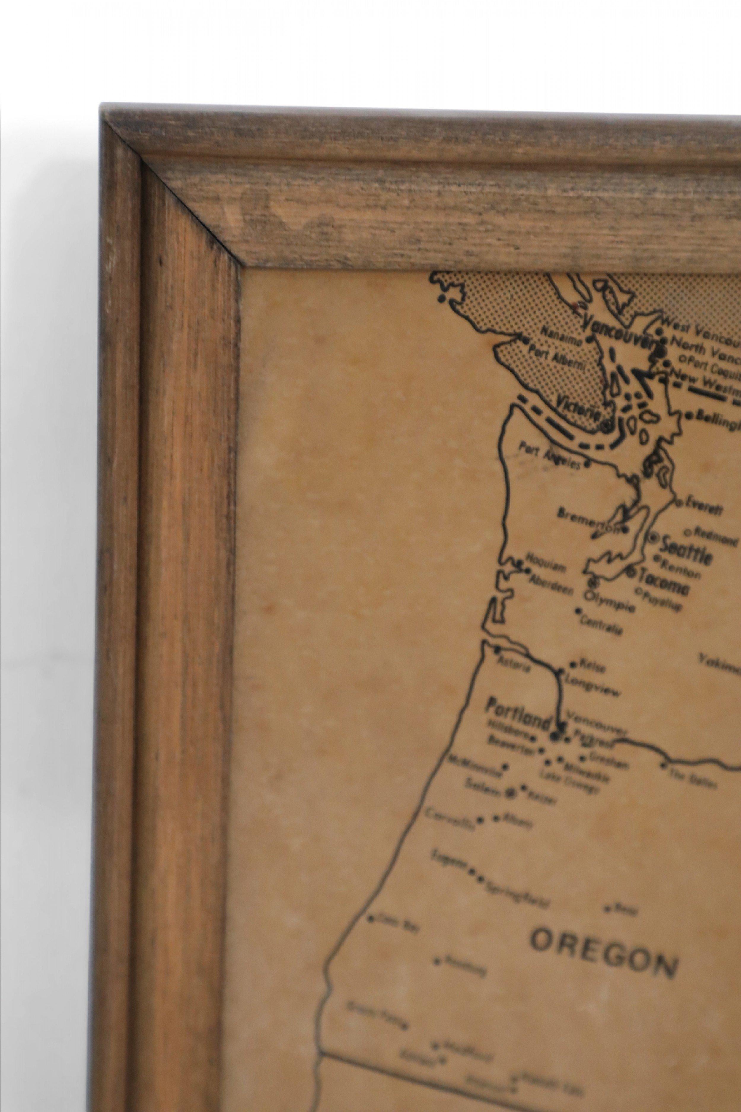 Vintage aged paper map of the United States mounted on particle board and framed in a simple wooden frame.