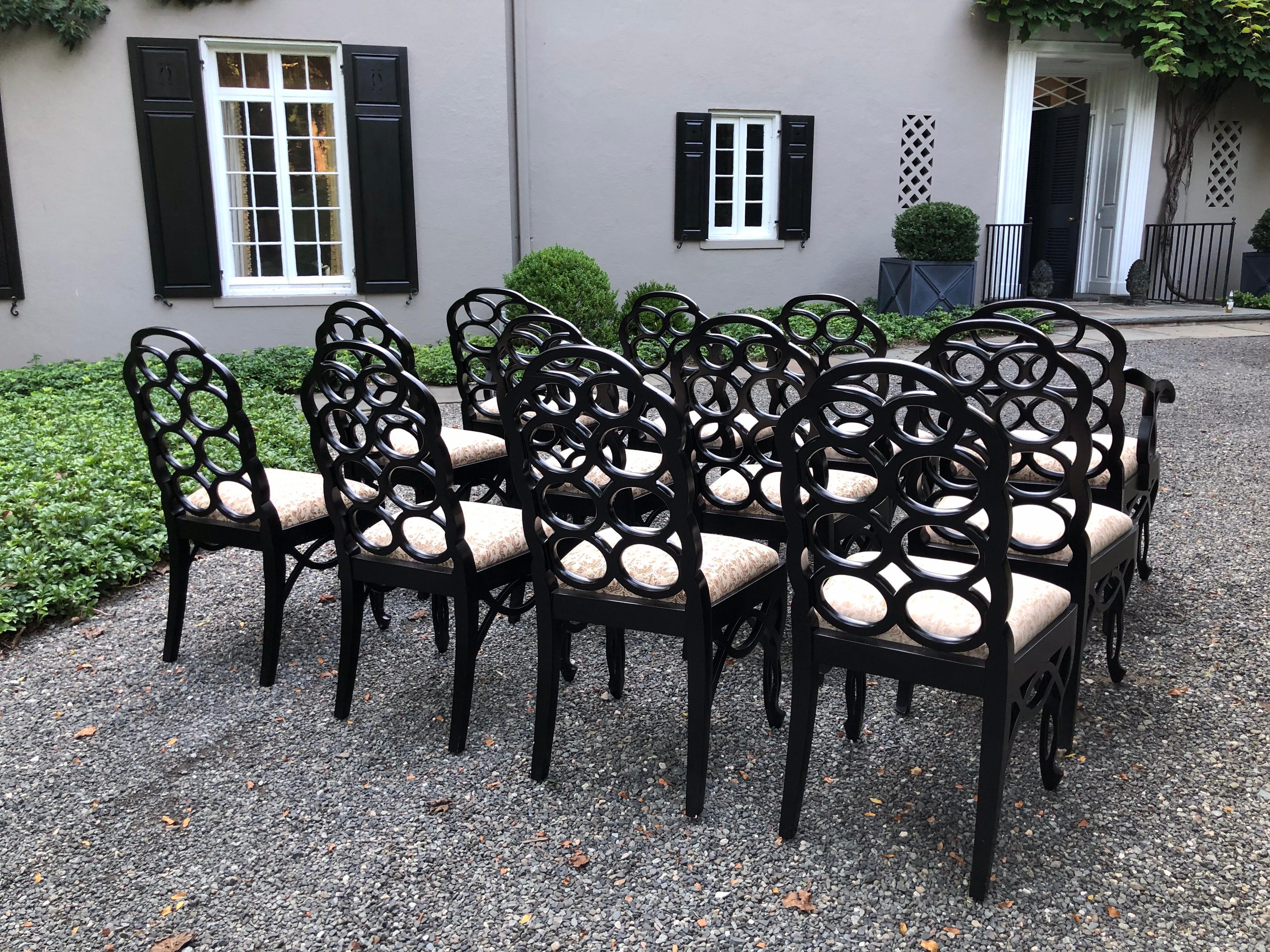 This is a rare set of twelve iconic Francis Elkins Loop chairs in a black satin matte lacquer. The seats with newer Fortuny fabric. The looped backs sit atop upholstered slip seats; chairs have a cabriole leg and an openwork skirt. Original