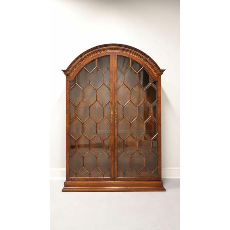 An Italian influenced display cabinet by Francesco Molon for Giemme of Romano d’Ezzelino, Italy. Burl Walnut wood, beveled glass doors, glass shelves and brass hardware. Features arched top with dentil moulding, two large diamond pattern beveled