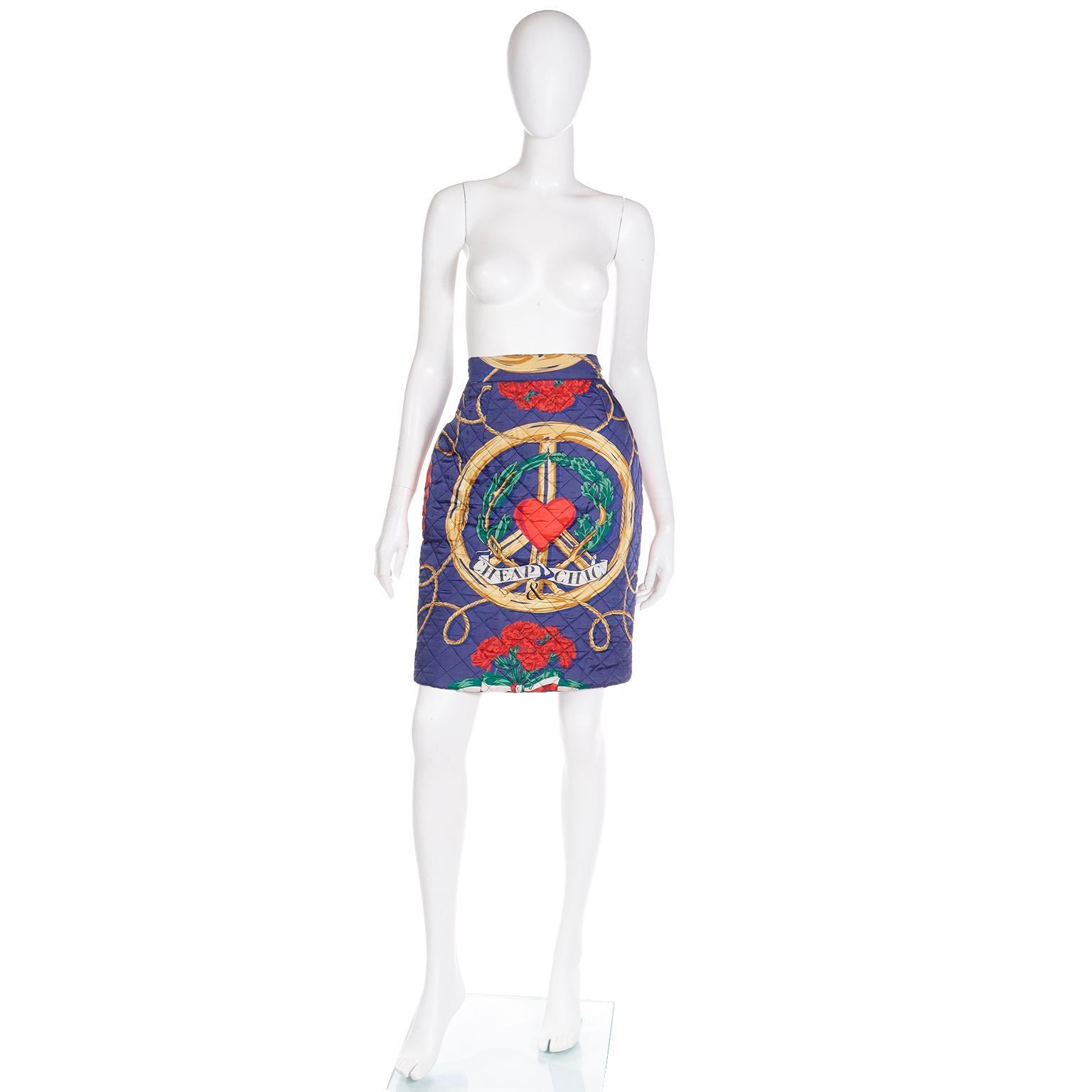 This vintage Franco Moschino quilted skirt features a large gold peace sign, red hearts and red flowers, rope and greenery with Cheap and Chic on a white banner on a blue background. The overall feel of the print is nautical and we love any of the
