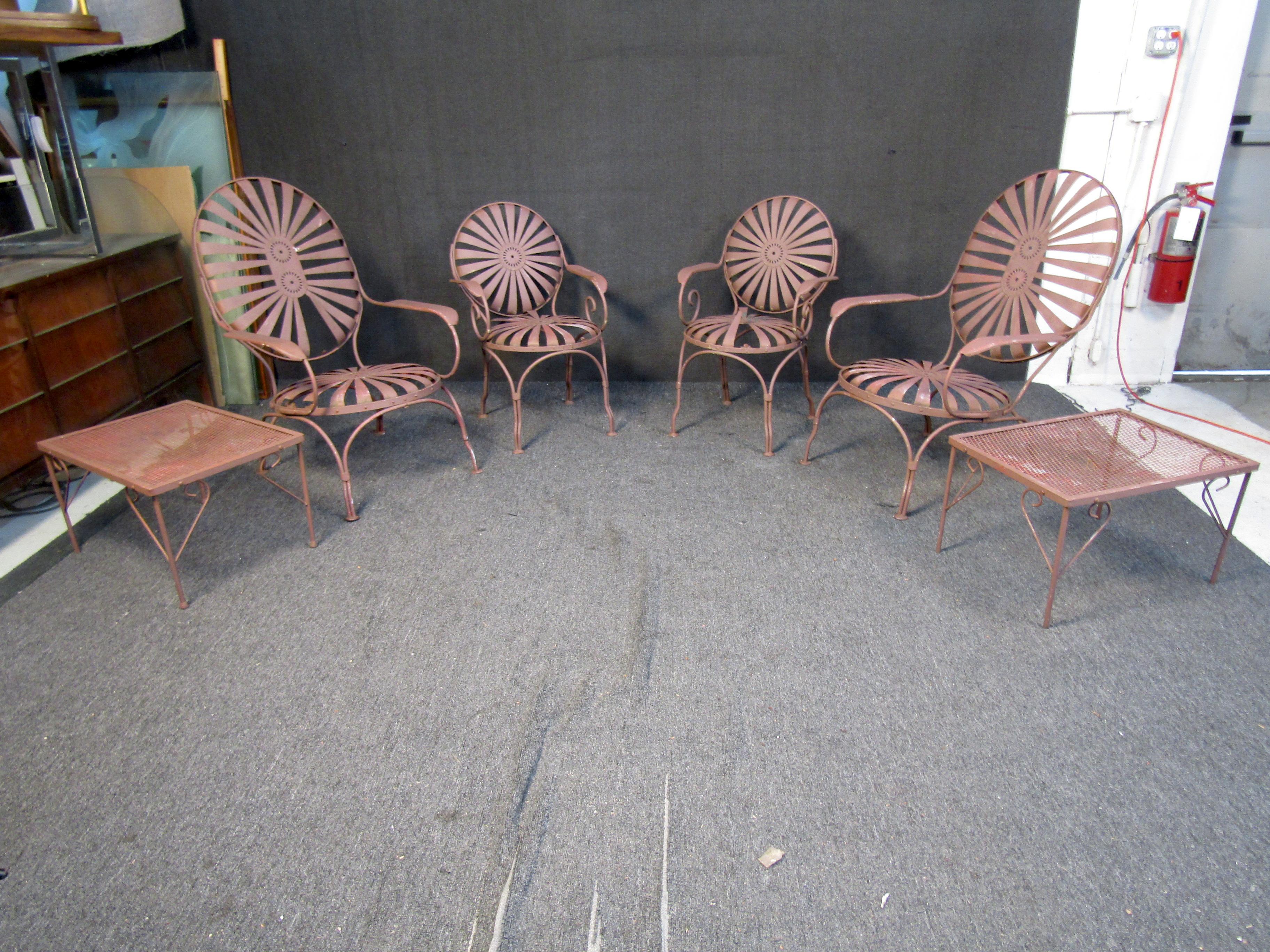 Antique outdoor furniture set by Francois Carre patented in 1866. The iron has a gorgeous, dark iron patina and a elegant art deco design that has stood the test of time. This set includes (2) large armchairs (2) small armchairs and (2) end tables.