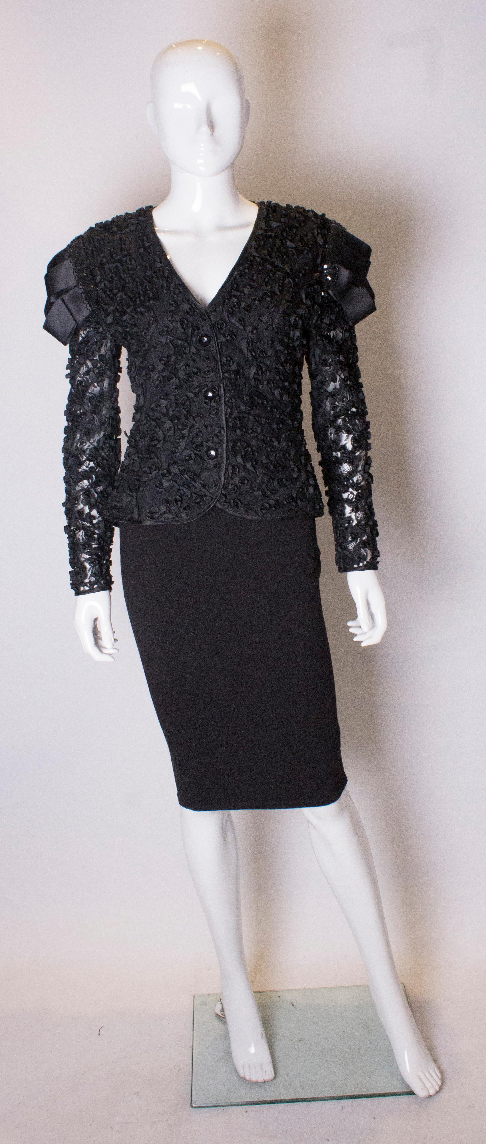 A chic vintage top by Frank Usher. The top is covered in ribbon work  and has a v neckline with bows and sequin on the shoulder.  It has decorative button s on the front and a zip opening at the back.